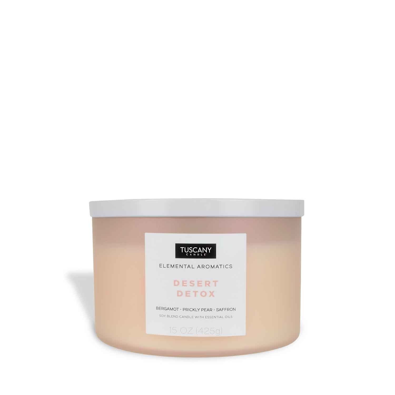 A Desert Detox scented-filled candle in a white jar with a pink lid, placed on a white background. (Brand: Tuscany Candle)