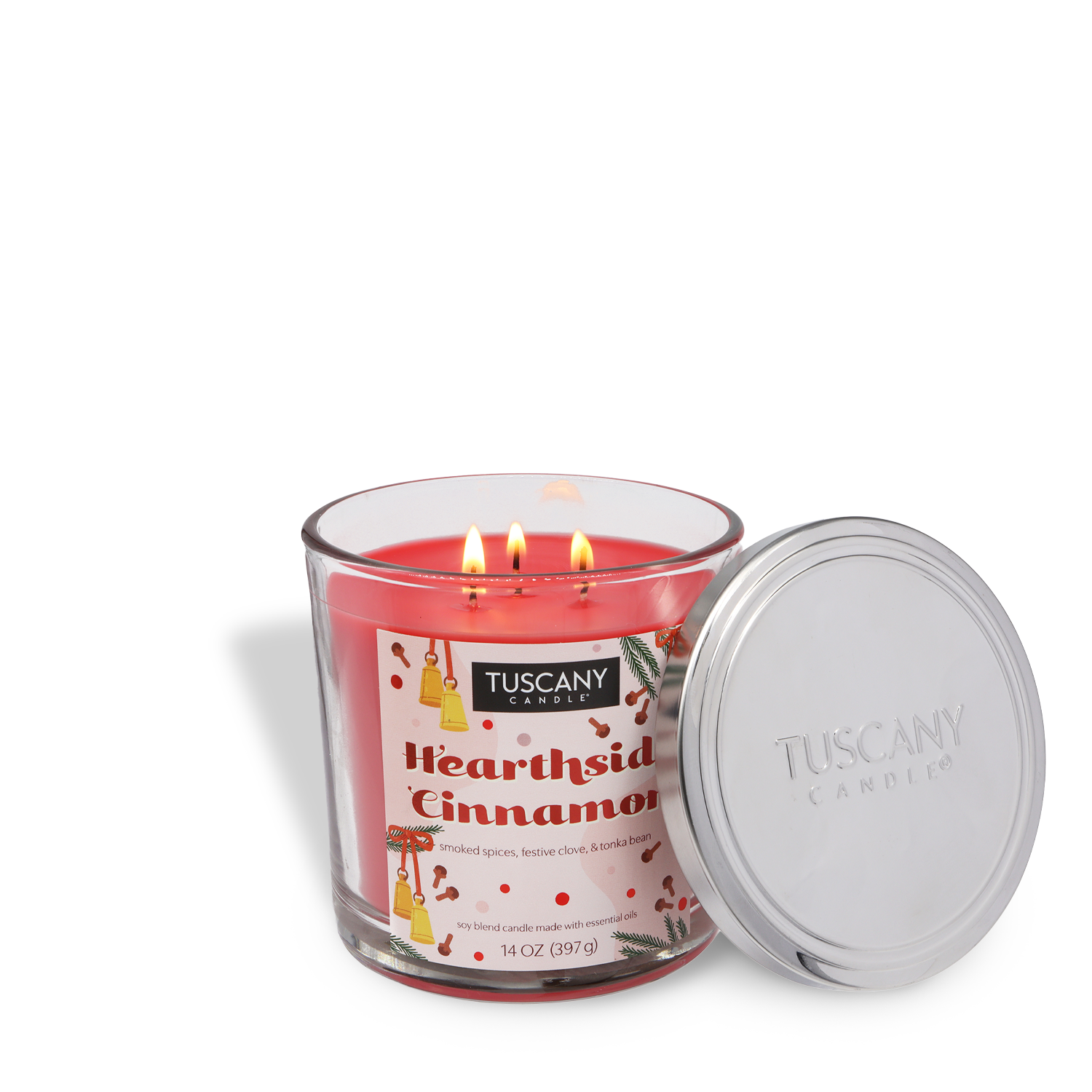 A Tuscany Candle® SEASONAL Hearthside Cinnamon Scented Holiday Candle (14 oz) jar features three lit wicks and comes with a silver lid beside it.