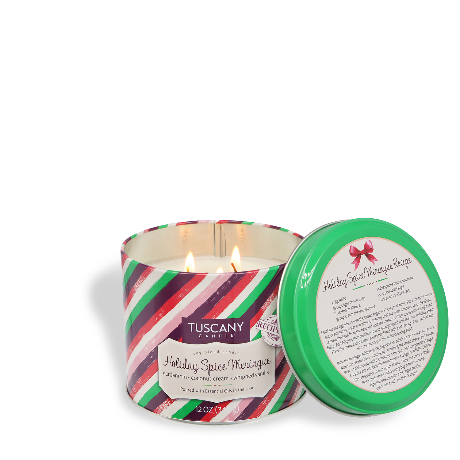 A Tuscany Candle® SEASONAL "Holiday Spice Meringue: Cardamom & Vanilla Scented Holiday Candle" (12 oz) from the Bakery Tins Collection, with stripes and two wicks, sits beside its green lid featuring a printed recipe.