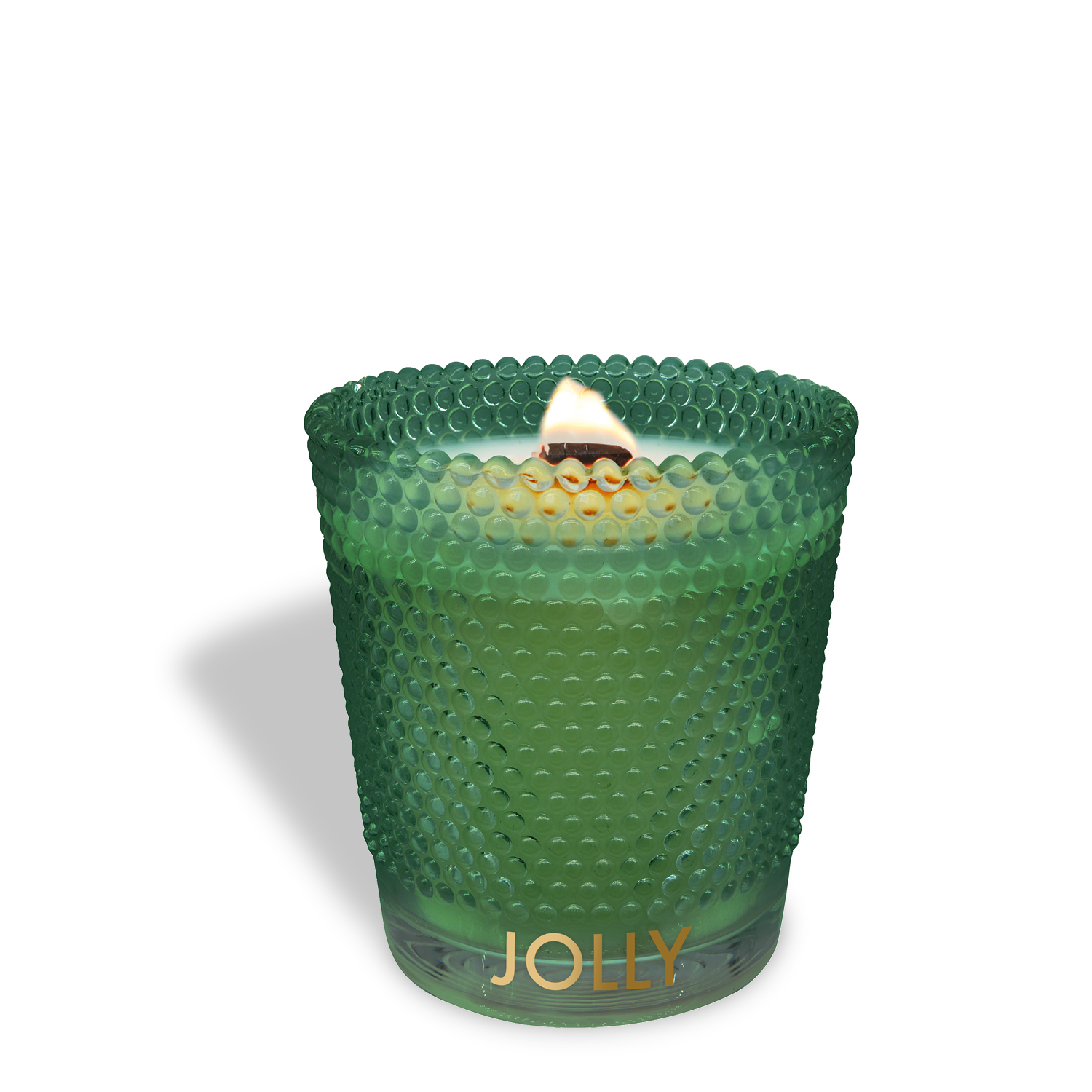 The Jolly: Spicy Clove & Frosted Spruce Scented Holiday Wooden Wick Candle (13 oz) by Tuscany Candle® SEASONAL is shown lit, in green textured glass with "JOLLY" in gold letters, casting a shadow on a white background.