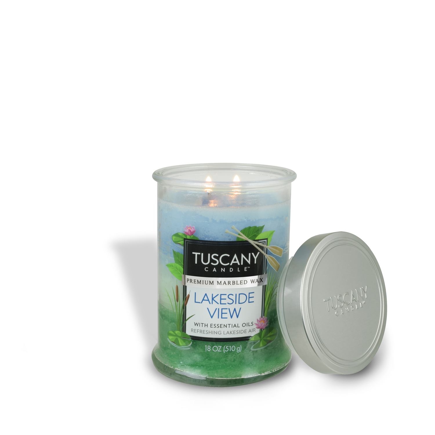 A lit Tuscany Candle® EVD jar labeled "Lakeside View," featuring marbled wax, greenery, and dragonfly imagery. The lid rests beside the 18 oz long-lasting scented candle jar.