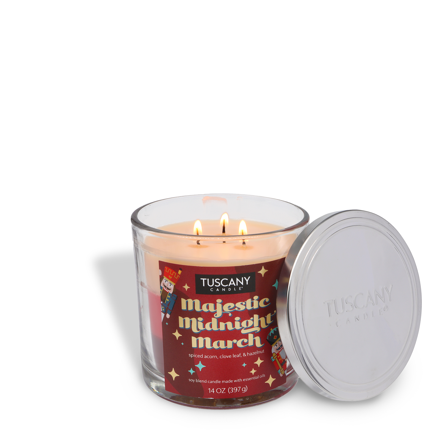 A Tuscany Candle® SEASONAL Majestic Midnight March Scented Holiday Candle (14 oz) with three lit wicks rests in a glass jar, silver lid set aside.