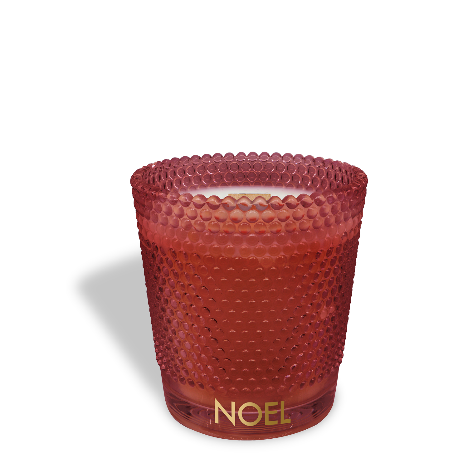 The Noel: Festive Sangria Scented Holiday Wooden Wick Candle (13 oz) by Tuscany Candle® SEASONAL features a red textured glass holder labeled "NOEL" with a white candle inside, casting a soft shadow on a white background.