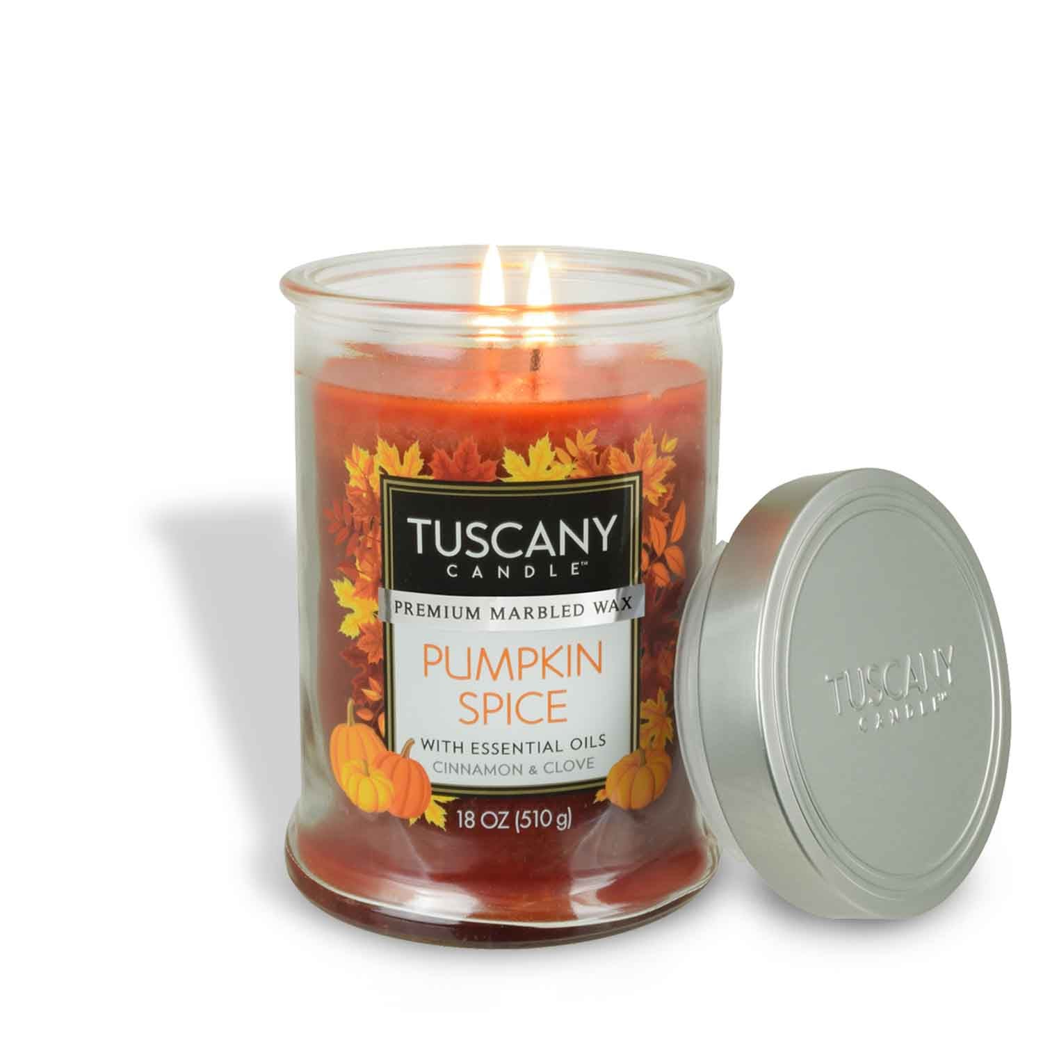 An 18 oz Pumpkin Spice scented jar candle with essential oils, featuring cinnamon and clove by Tuscany Candle® EVD, is lit with its silver lid placed beside it.
