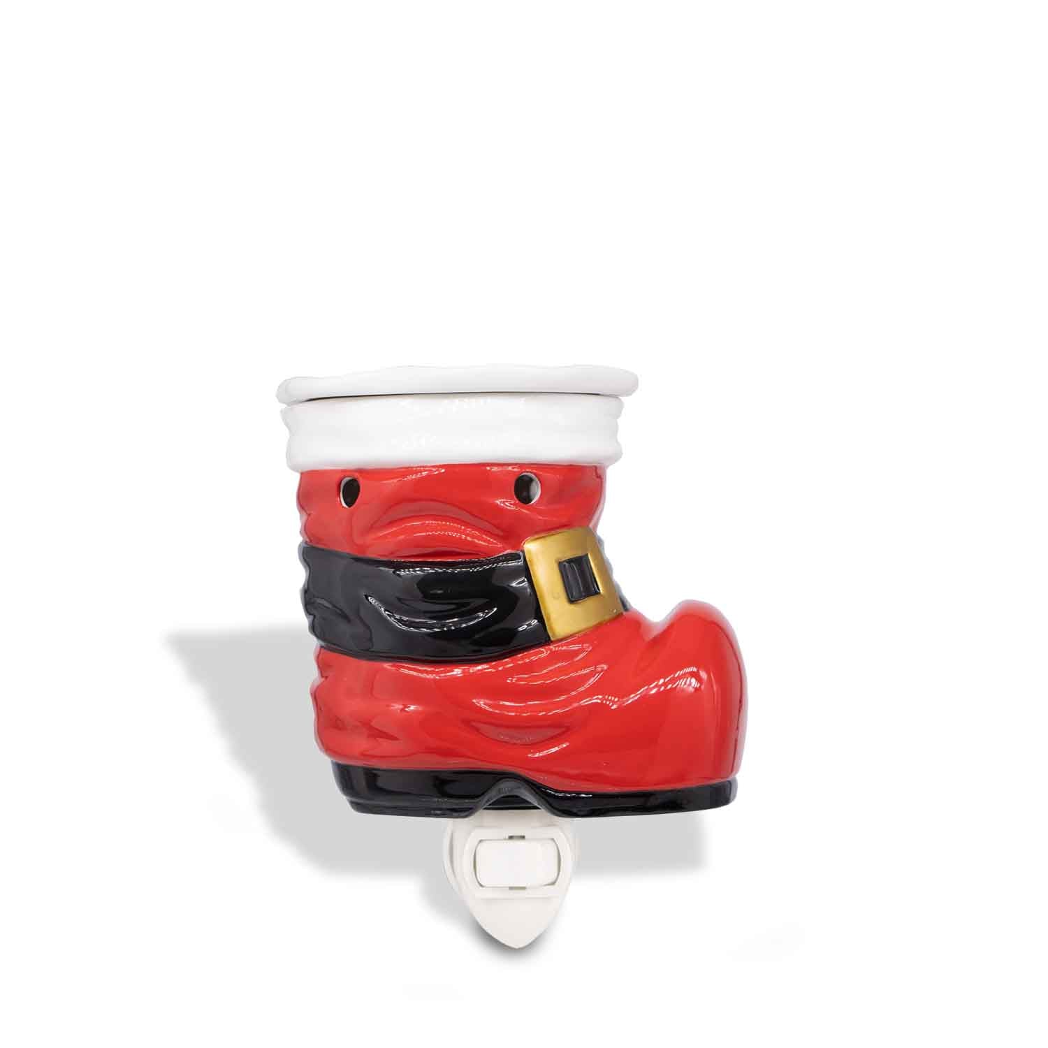 A Tuscany Candle ceramic wax melt warmer in the shape of Santa's Boot Outlet, perfect for adding a festive touch to your home during the holidays.