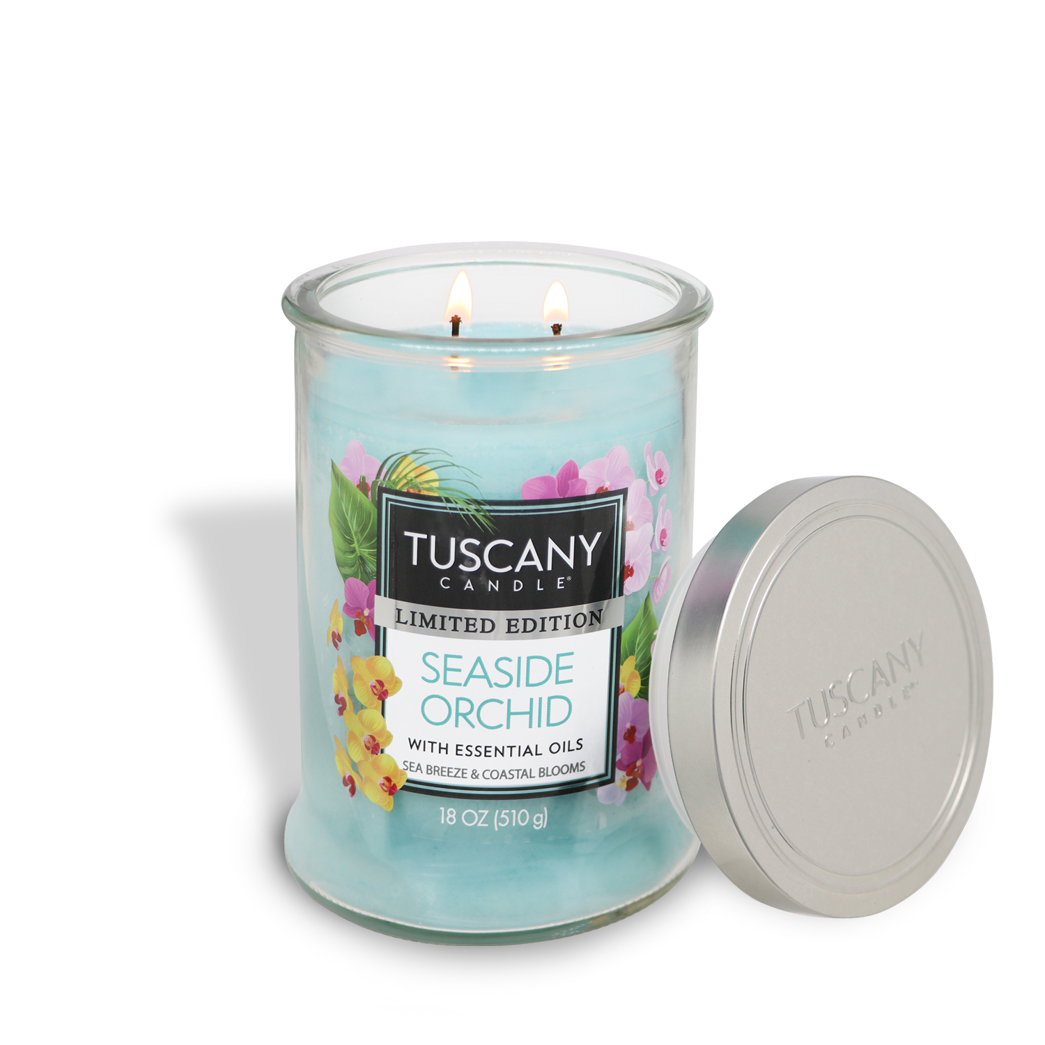 The Tuscany Candle® SEASONAL Seaside Orchid: Coastal Scented Summer Candle (18 oz) features two lit wicks and a silver lid, filling your space with the refreshing aroma of coastal blooms—ideal for summer.