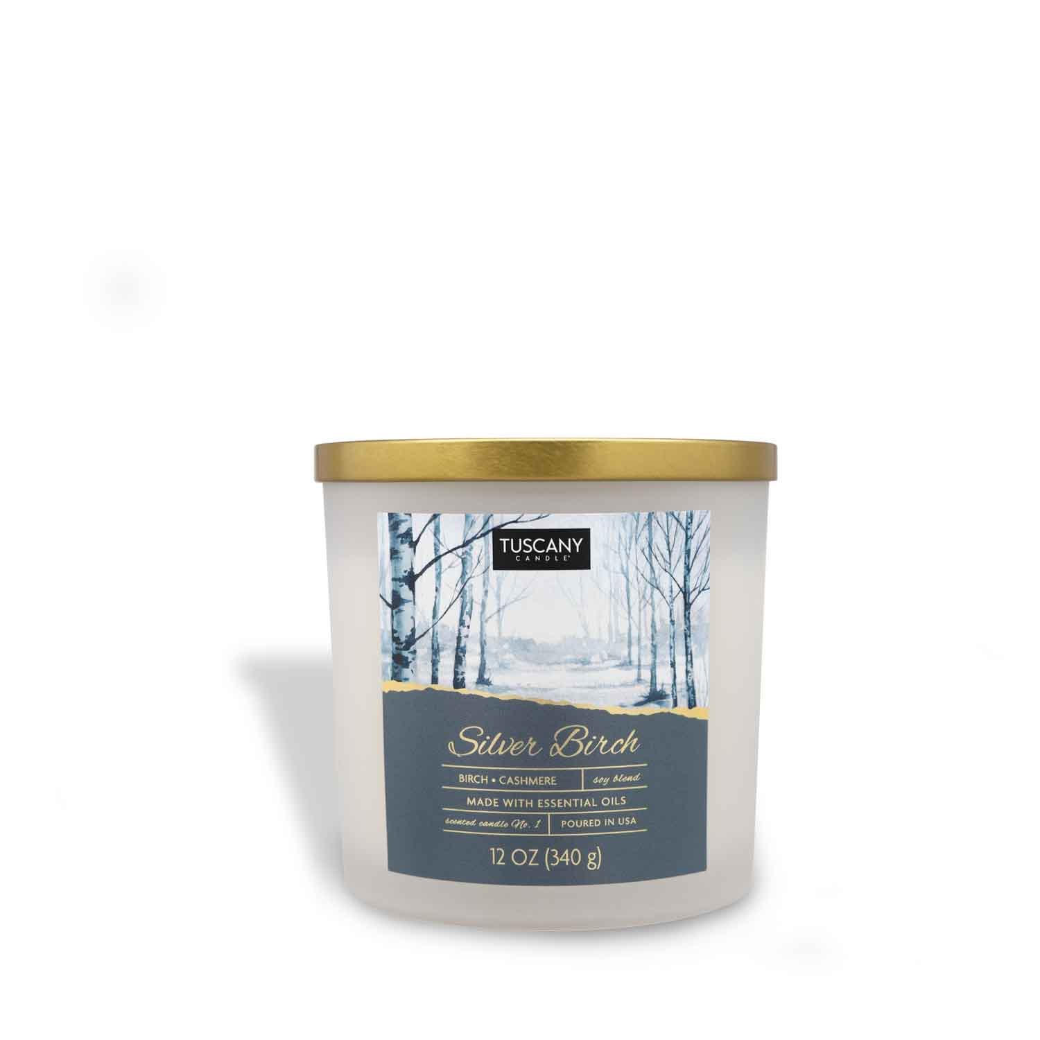 12oz Silver Birch scented candle in a frosted glass jar with a golden lid, filled with white wax, radiating aromas of white winter birch, cashmere, and vanilla from the Christmas candle collection.