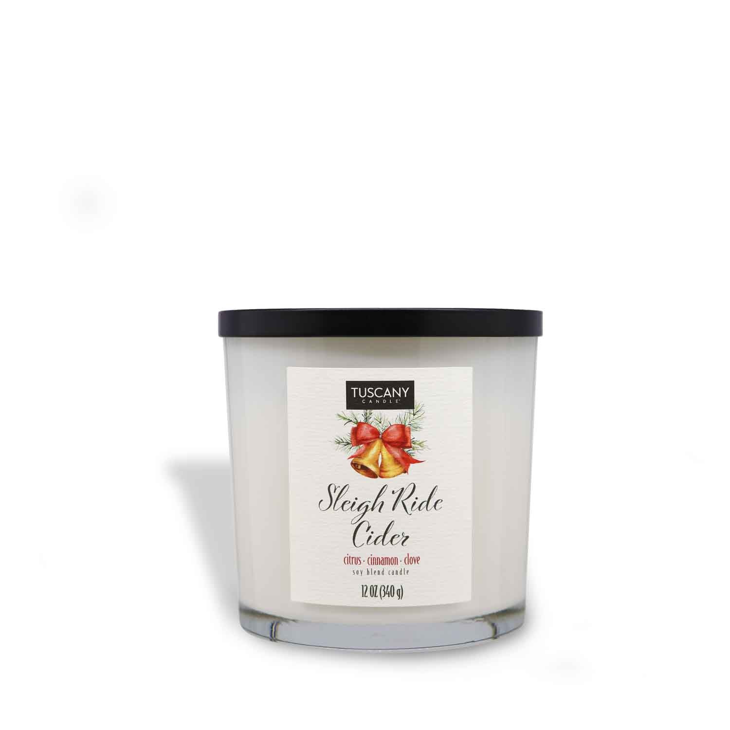 12oz Sleigh Ride Cider scented candle in a glossy white glass jar with a gold lid, evoking the scent of crisp citrus intertwined with warming cinnamon from the Winter candle collection.