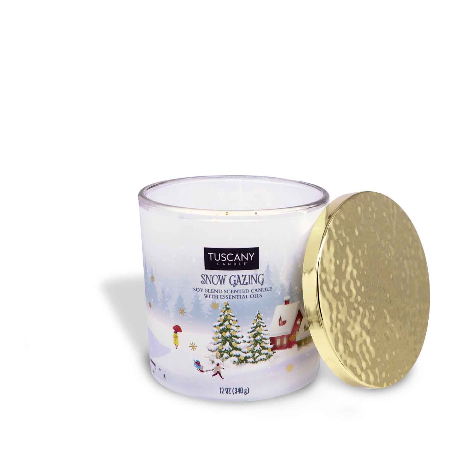 12oz Snow Gazing scented candle in a frosted glass jar with a gold lid, filled with white wax, emanating fragrances of fresh snow, soft woods, bergamot, and jasmine from the Christmas candle collection.