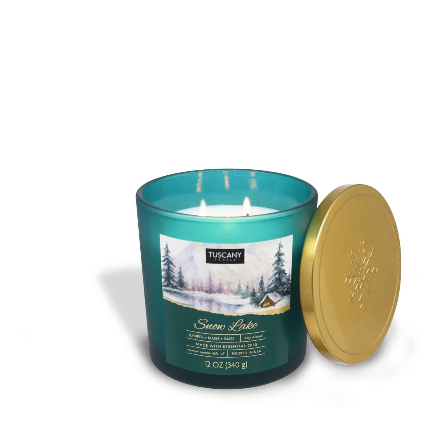 A Snow Lake Long-Lasting Scented Jar Candle (12 oz) from the Snowscapes Collection by Tuscany Candle with a gold lid on a white background from the Winter candle collection.