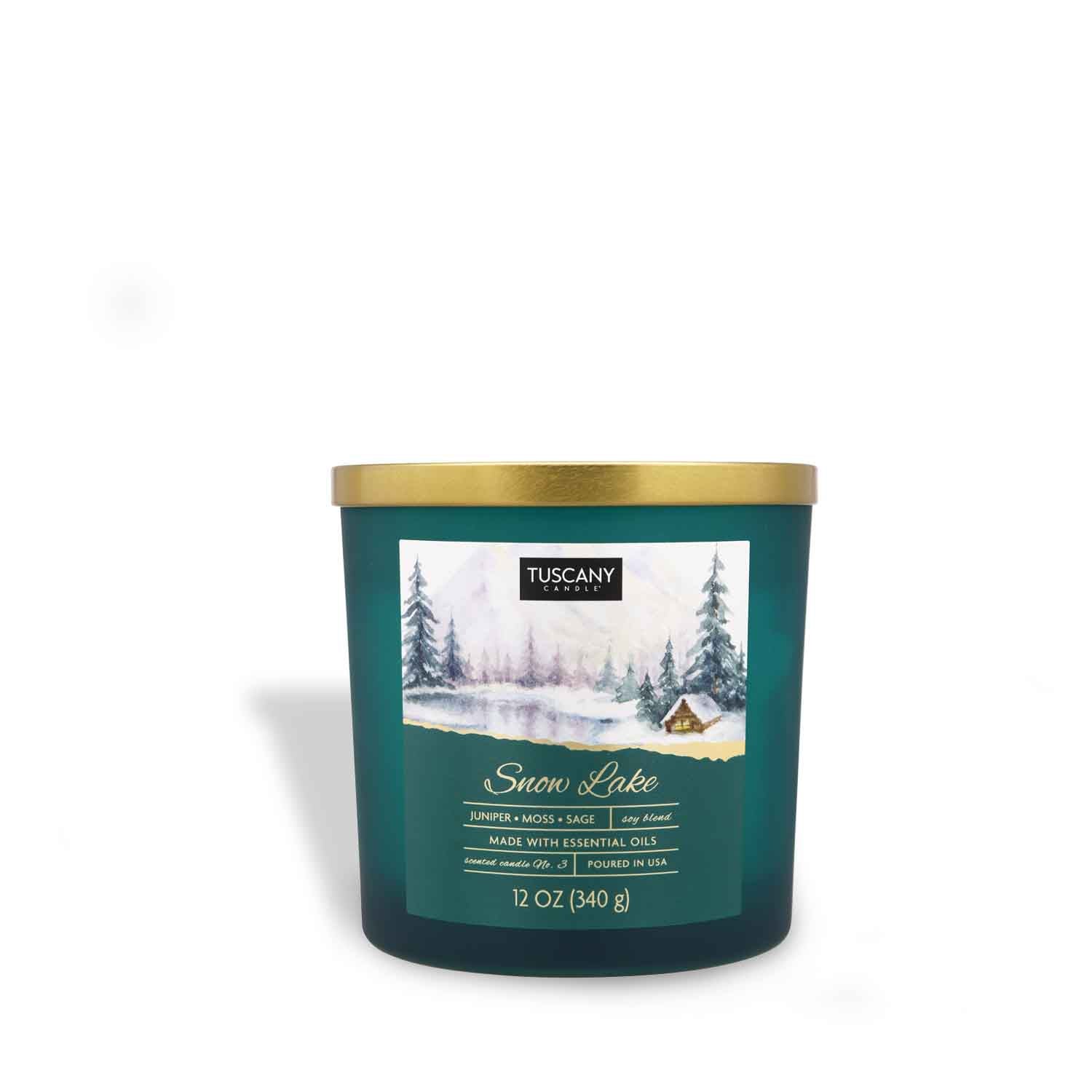 A Snow Lake Long-Lasting Scented Jar Candle (12 oz) from the Tuscany Candle brand, with a green lid and gold trim, perfect for creating a winter lakeside ambiance.