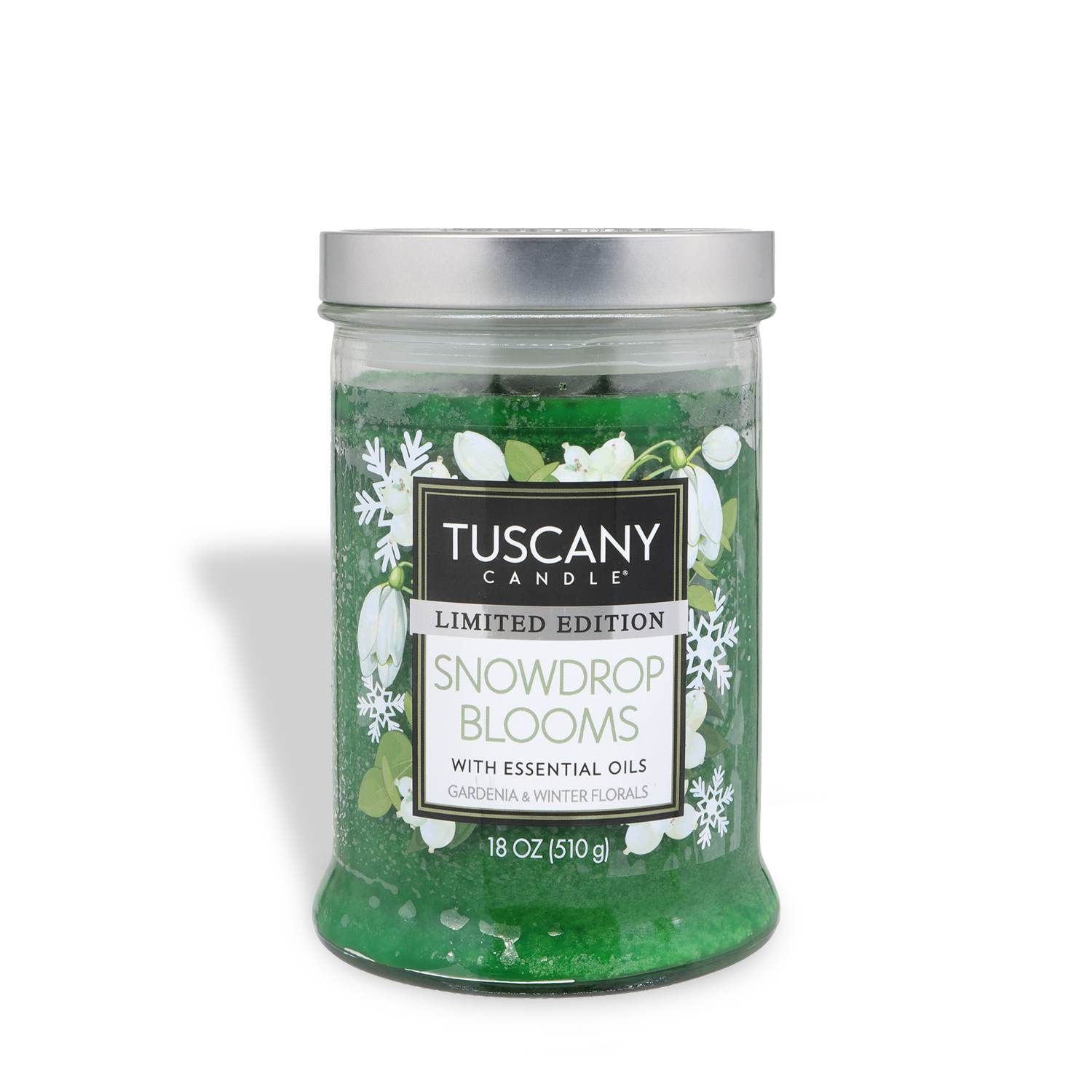 An 18 oz clear glass jar of Tuscany Candle® SEASONAL Snowdrop Blooms: Gardenia & Winter Florals scented holiday candle with essential oils, green wax, and a silver lid.