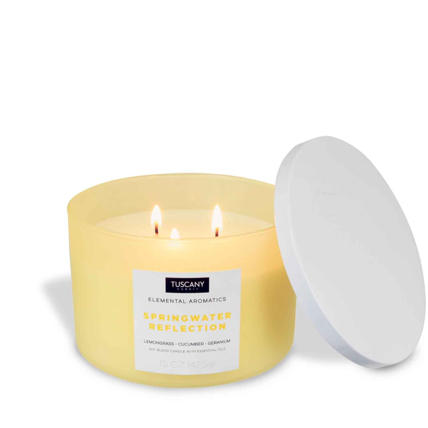 A Springwater Reflection-scented yellow candle with a white lid, made with a soy wax blend, on a white background by Tuscany Candle.