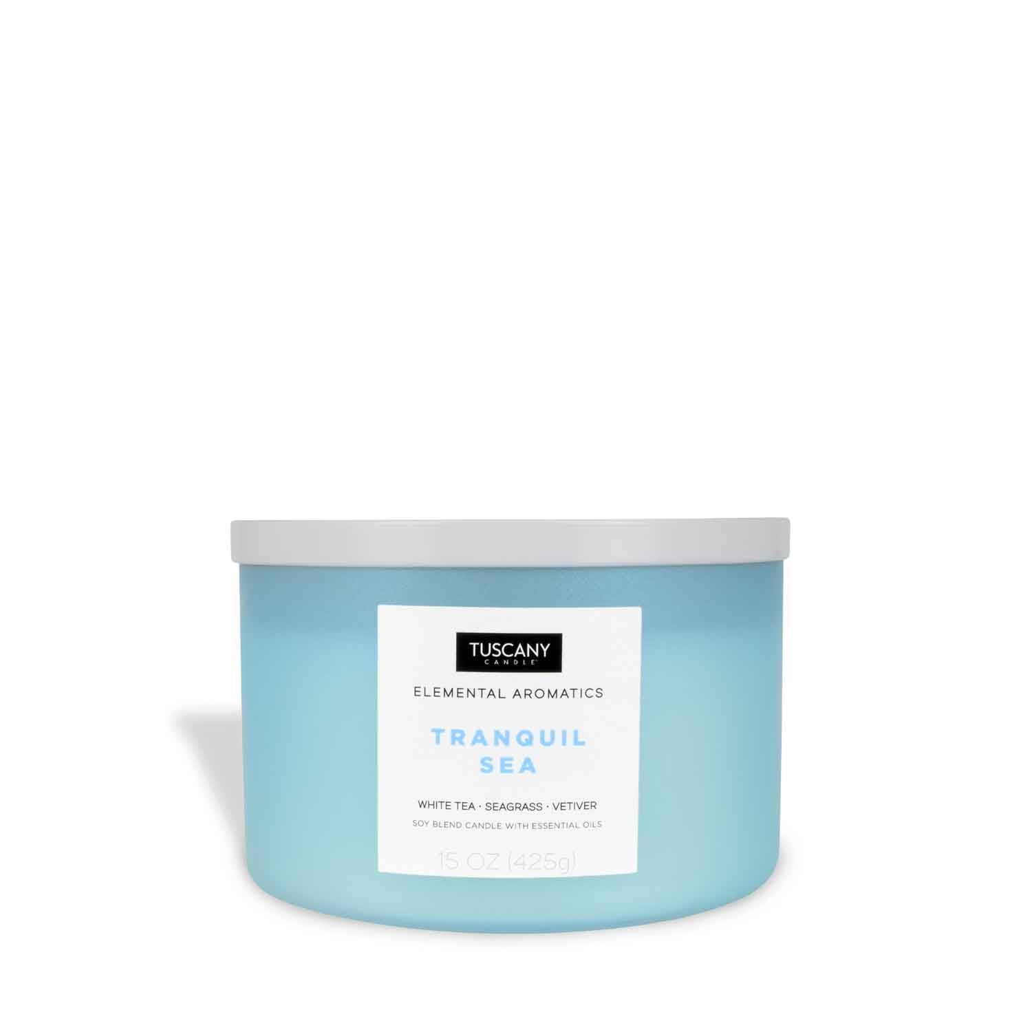 A Tranquil Sea Scented Jar Candle (15oz) – Elemental Aromatics Collection by Tuscany Candle® EVD, with a serene blue lid, containing a scented candle that embodies the calming essence of the ocean.