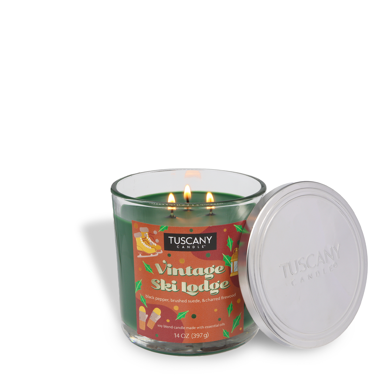 A green Tuscany Candle® SEASONAL "Vintage Ski Lodge" Scented Holiday Candle (14 oz) with three wicks, in a glass jar, is shown with a silver lid beside it.