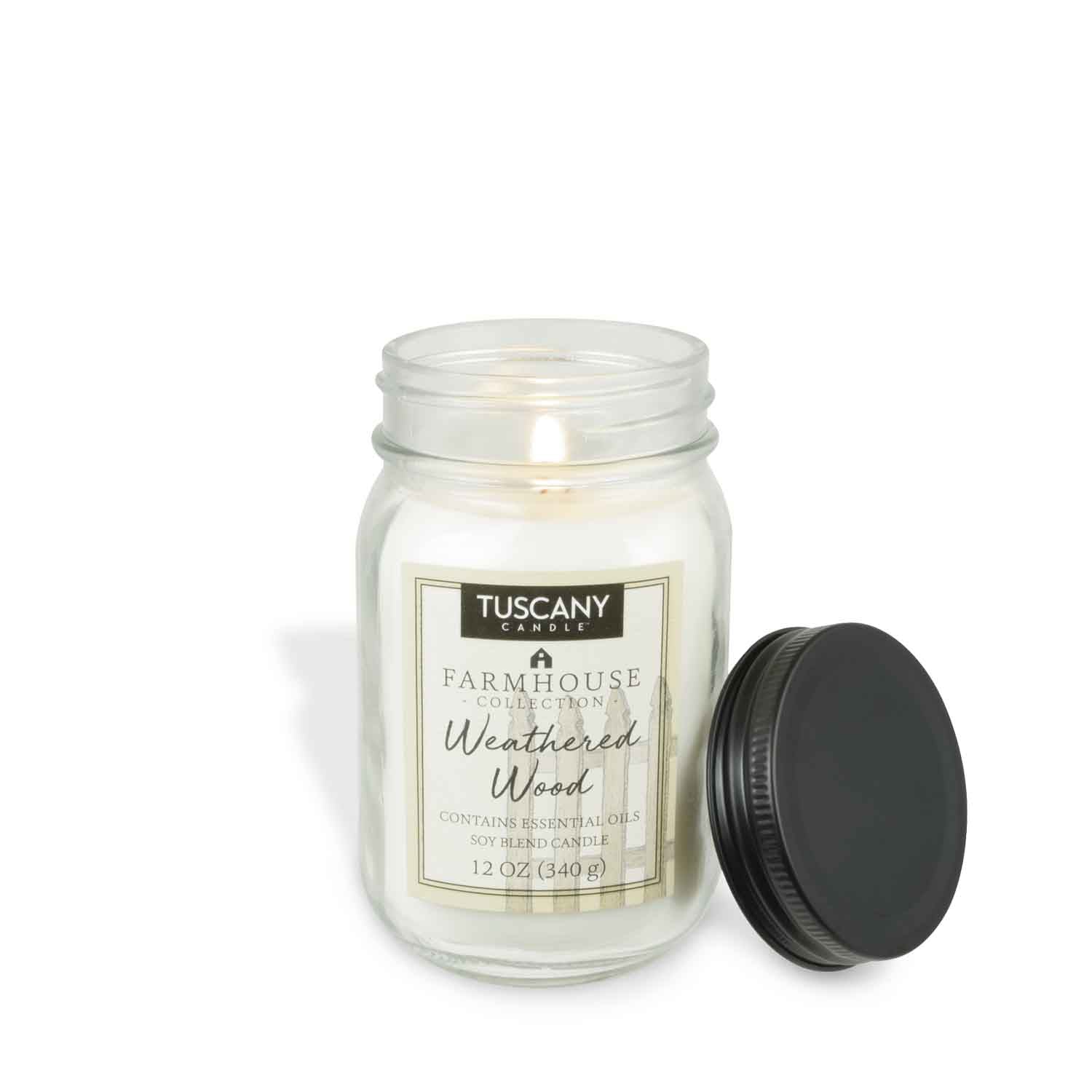 12oz 'Weathered Wood' scented candle in a clear mason jar with a black lid, embodying the rustic farmhouse charm and the comforting scent of sun-washed wood and fresh air.