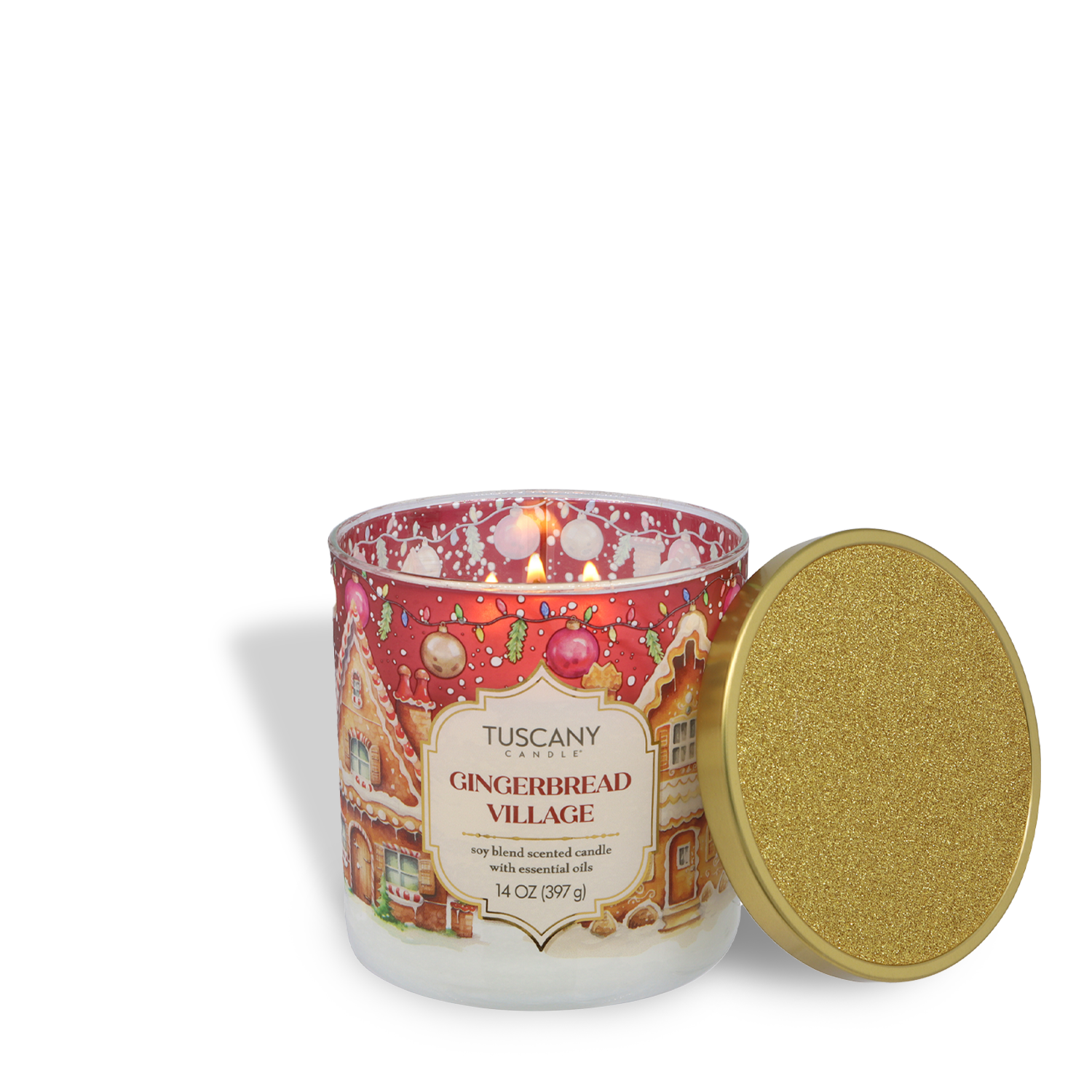 A Tuscany Candle® SEASONAL “Gingerbread Village: Classic Gingerbread & Sugar” Traditions Collection candle (14 oz) with a gold glitter lid sits beside its glass jar, which features festive gingerbread house artwork.