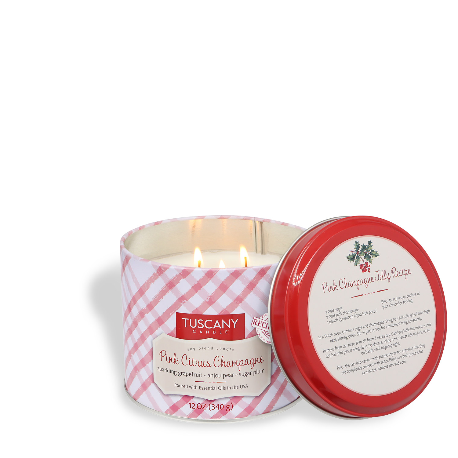 The Tuscany Candle® SEASONAL Pink Citrus Champagne: Grapefruit & Pear Scented Holiday Candle (12 oz) from the Bakery Tins Collection features a pink plaid design and a red lid displaying a pink champagne jelly recipe.