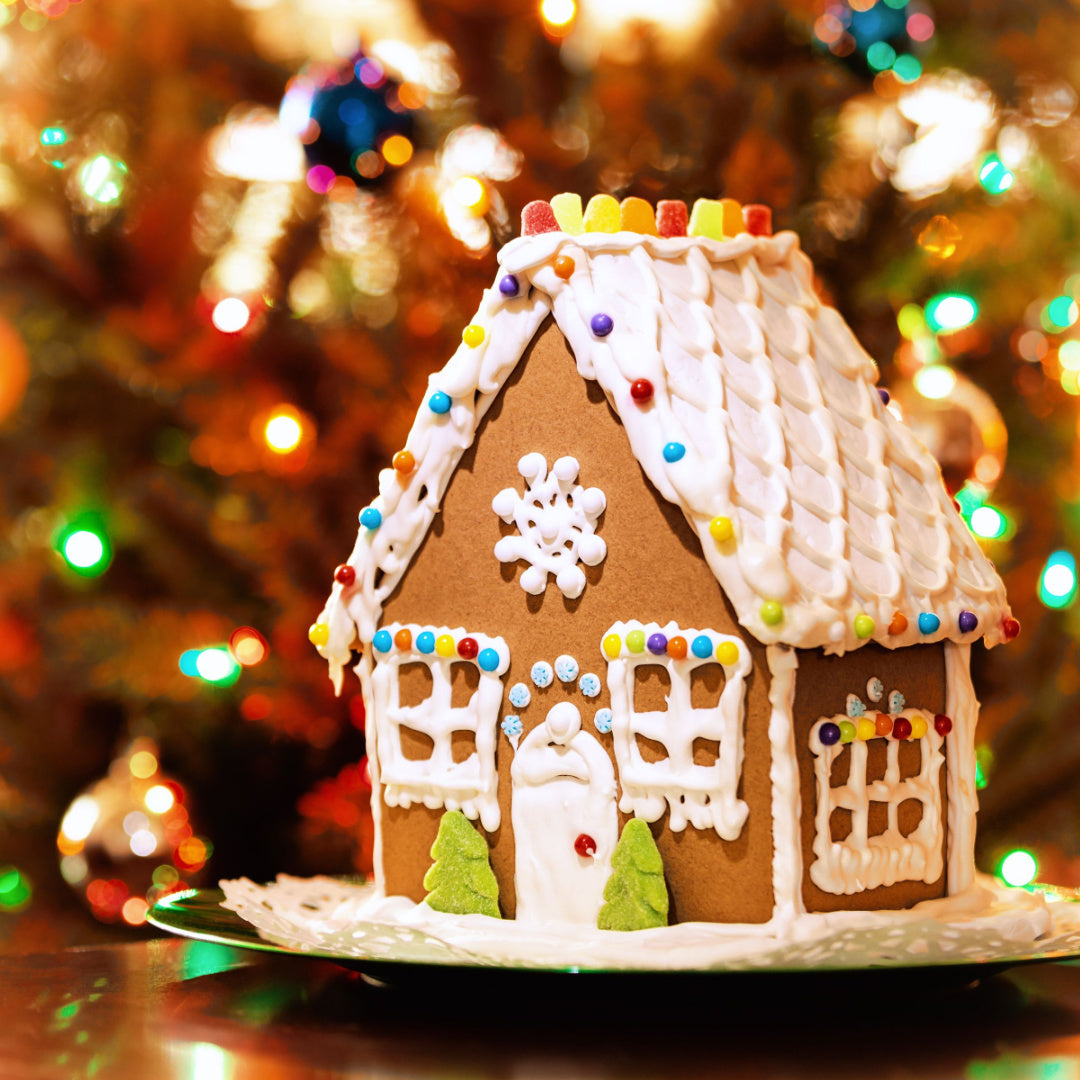A photo of a frosted gingerbread house - the inspiration for Tuscany Candle's Limited Edition Holiday scented candle