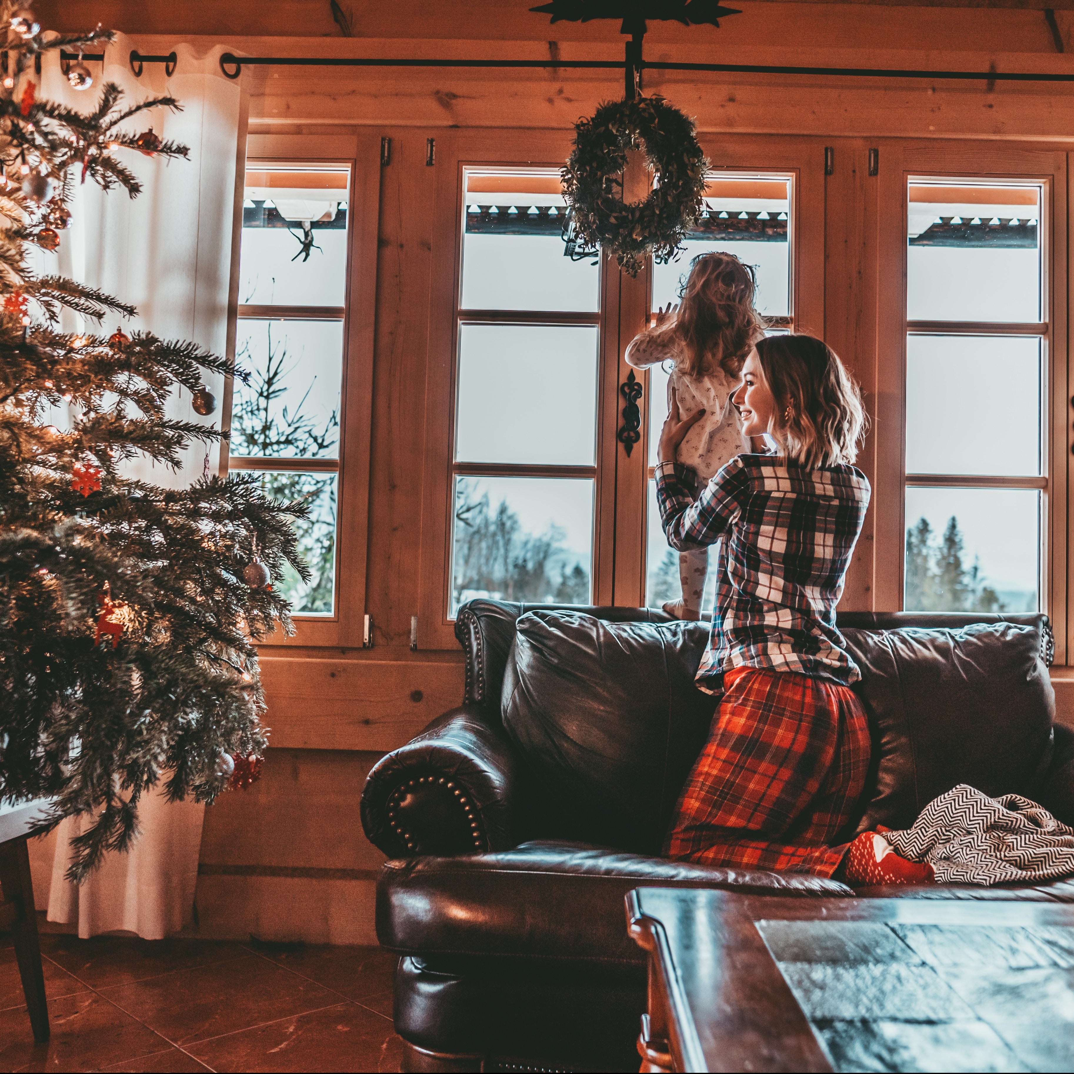 Christmas morning in a mountain cabin - a mother and small daugther look out the window for reindeer tracks. This sensation is the inspiration behind this christmassy candle