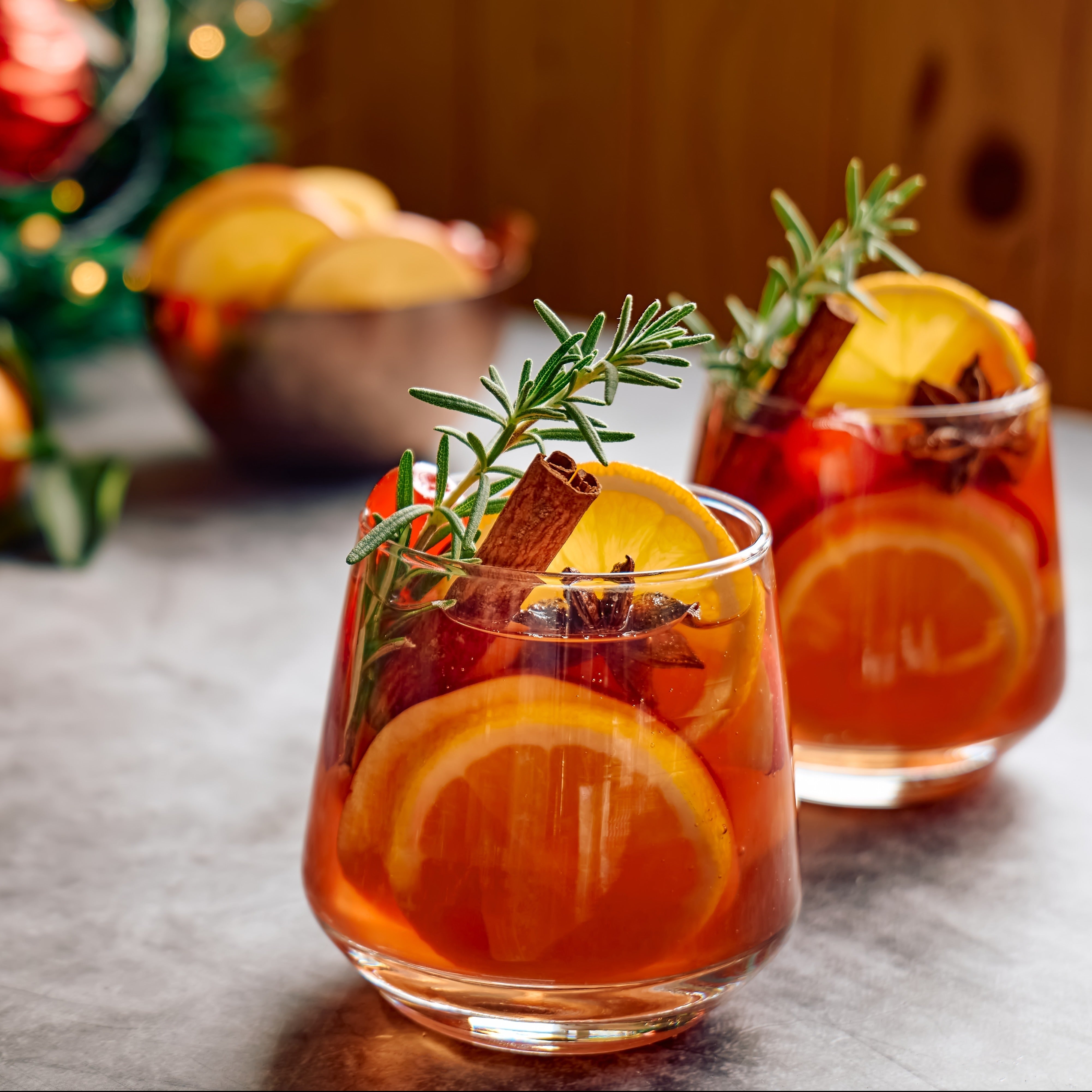 12oz Sleigh Ride Cider scented candle in a glossy white glass jar with a gold lid, evoking the scent of crisp citrus intertwined with warming cinnamon from the Winter candle collection.