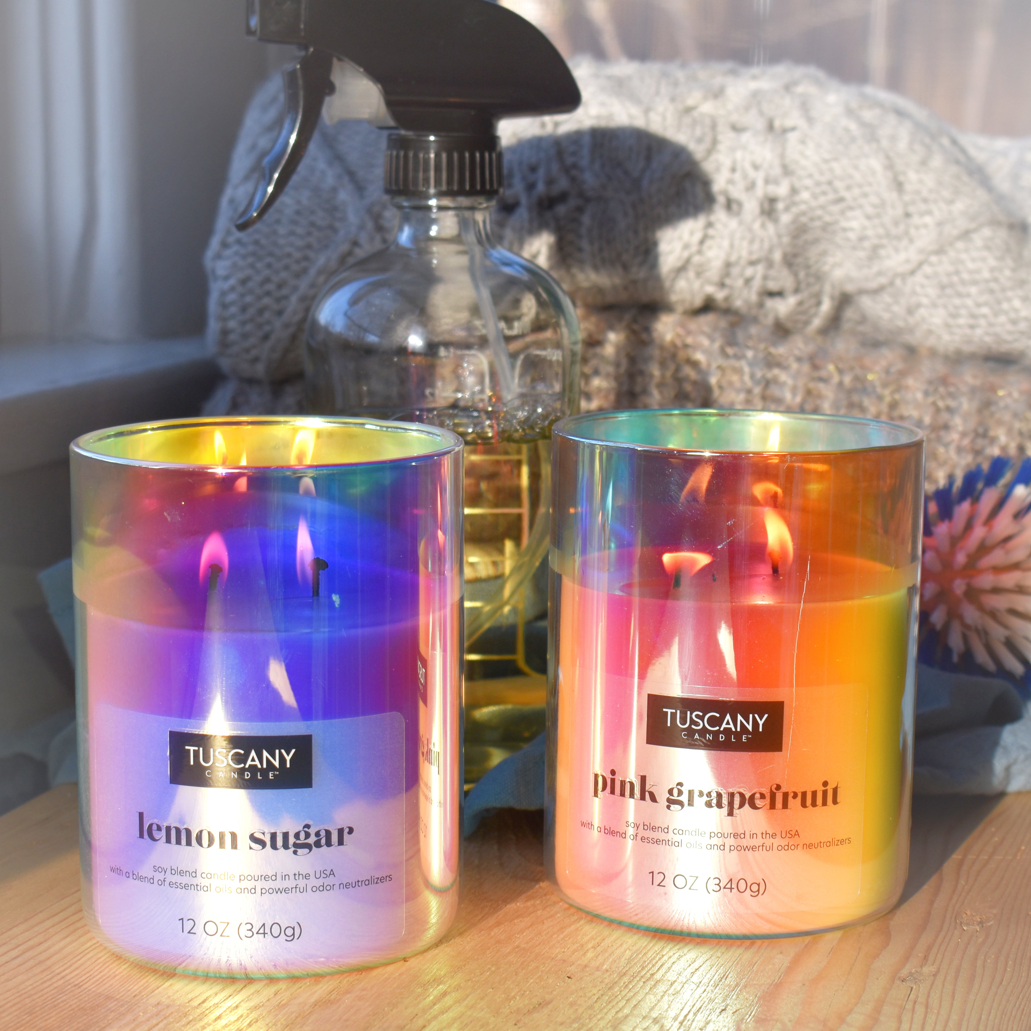 A still life of two candles, including Pink Grapefruit, a mal odor control scented candle from Tuscany' Candle's Serene Clean® collection of scented candles and fragrance bars