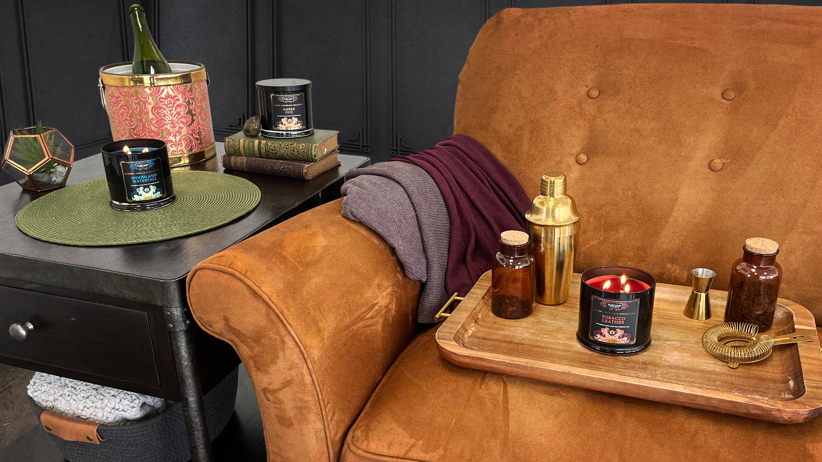Homme + Heritage Collection displayed on a suede brown couch and modern side table.