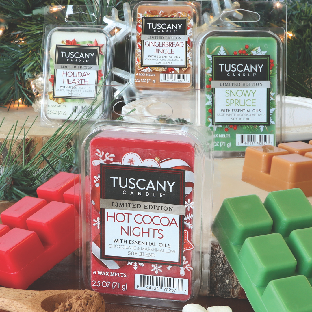 An arrangement of Tuscany Candle® SEASONAL wax melts, including Holiday Hearth Scented Wax Melt (2.5 oz), Gingerbread Jingle, Snowy Spruce, and Hot Cocoa Nights, elegantly displayed on a table adorned with holiday decorations.