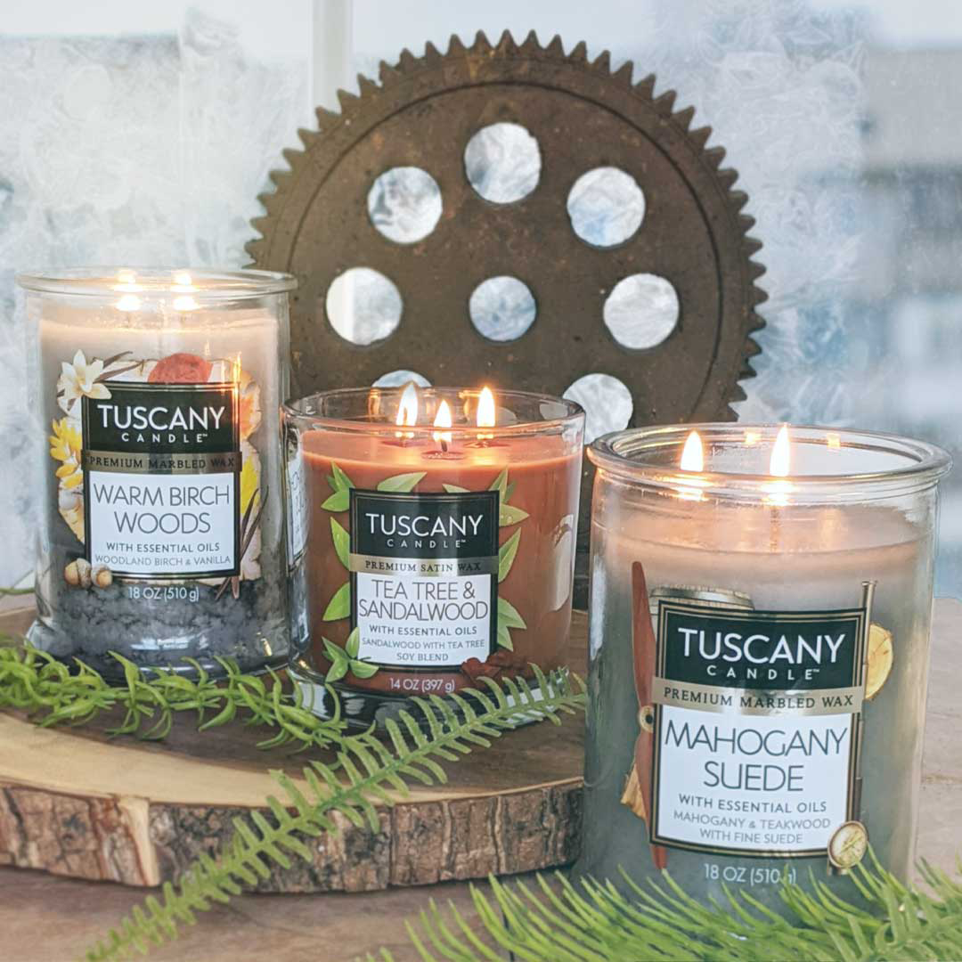 Three Tea Tree & Sandalwood Long-Lasting Scented Jar Candles (14 oz) by Tuscany Candle, elegantly placed on a rustic wooden table.