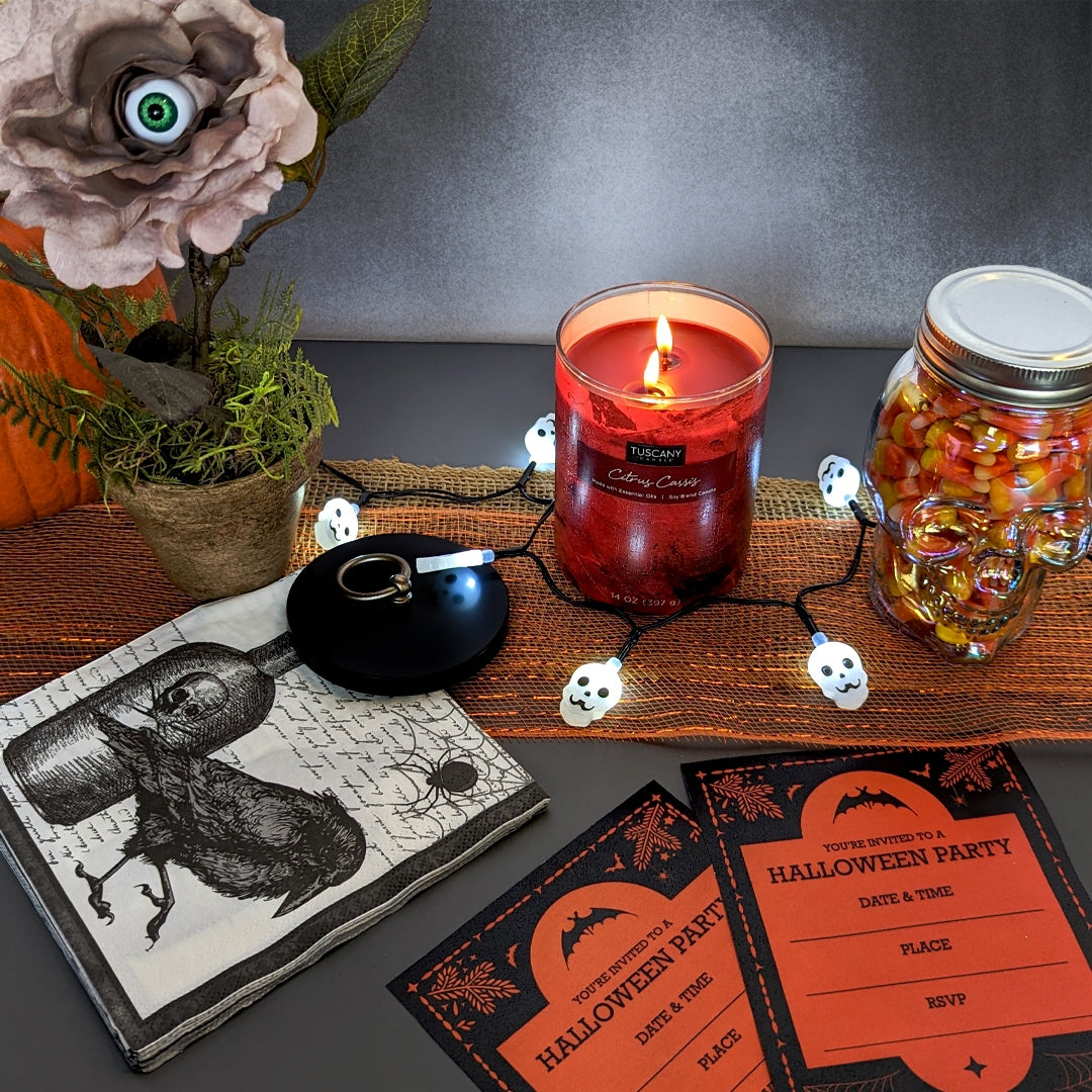 A Halloween party with a Tuscany Candle Citrus Cassis Scented Jar Candle (14 oz) – Home Décor Collection, candy jar, and festive fragrance.