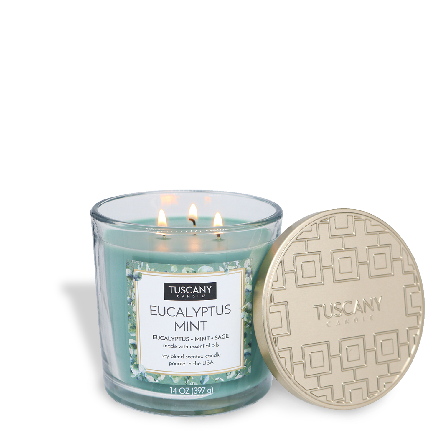 A Tuscany Candle® EVD Eucalyptus Mint Long-Lasting Scented Jar Candle (14 oz), made with essential oils, burns in a glass jar with its gold lid set beside it.