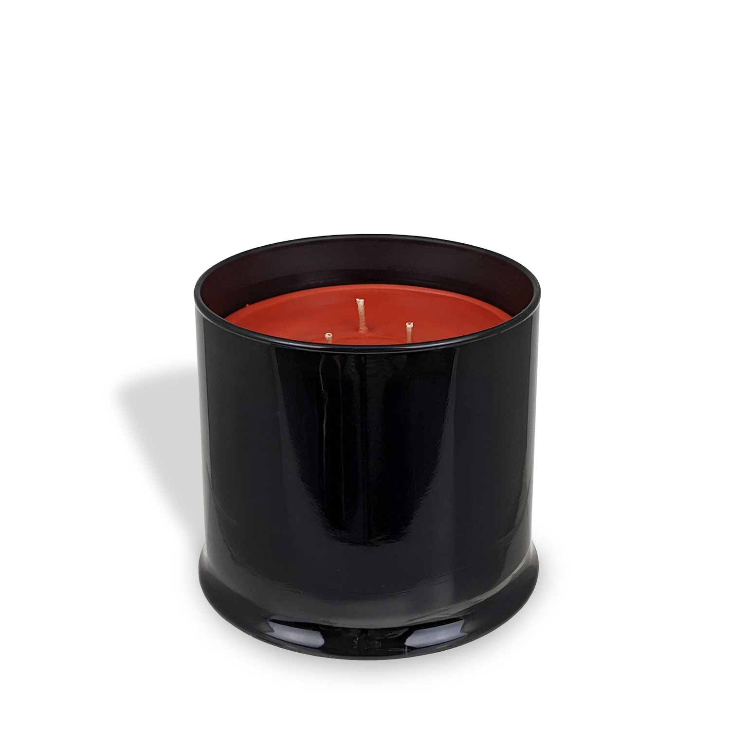 The Tuscany Candle® EVD Tobacco Leather Scented Jar Candle (15 oz) from the Homme + Heritage Collection features a black glass jar with red wax and three wicks, filling your space with a vintage leather fragrance.