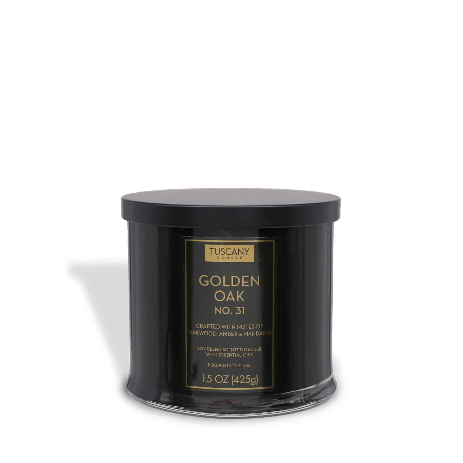 The Tuscany Candle® EVD Golden Oak Scented Jar Candle (15 oz) from the Homme + Heritage Collection features sandalwood, amber, and mandarin notes in a black lidded jar.