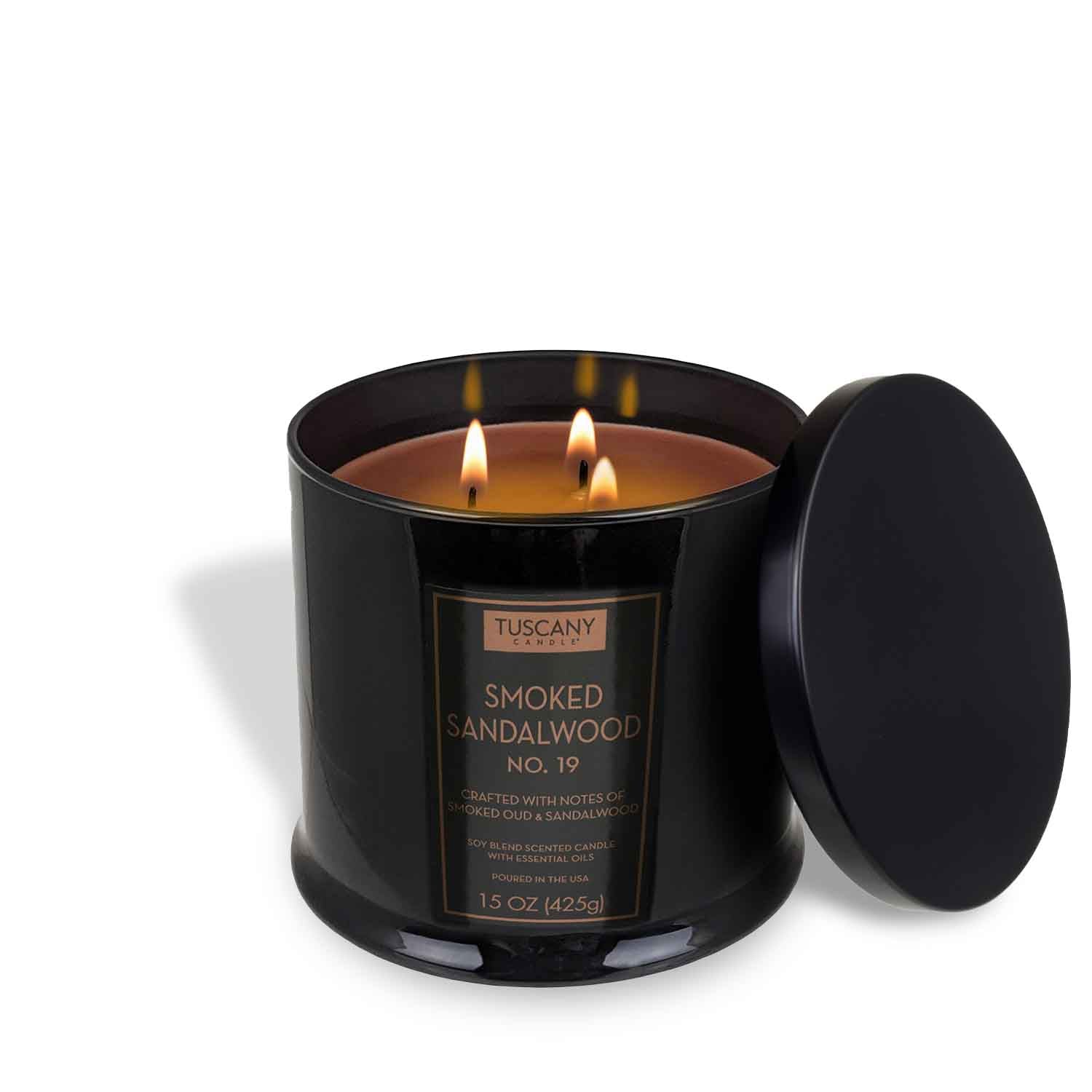 The Tuscany Candle® EVD Smoked Sandalwood Scented Jar Candle (15 oz) from the Homme + Heritage Collection features a black glass jar with two wicks and a rich, masculine aroma, perfect for filling any room.