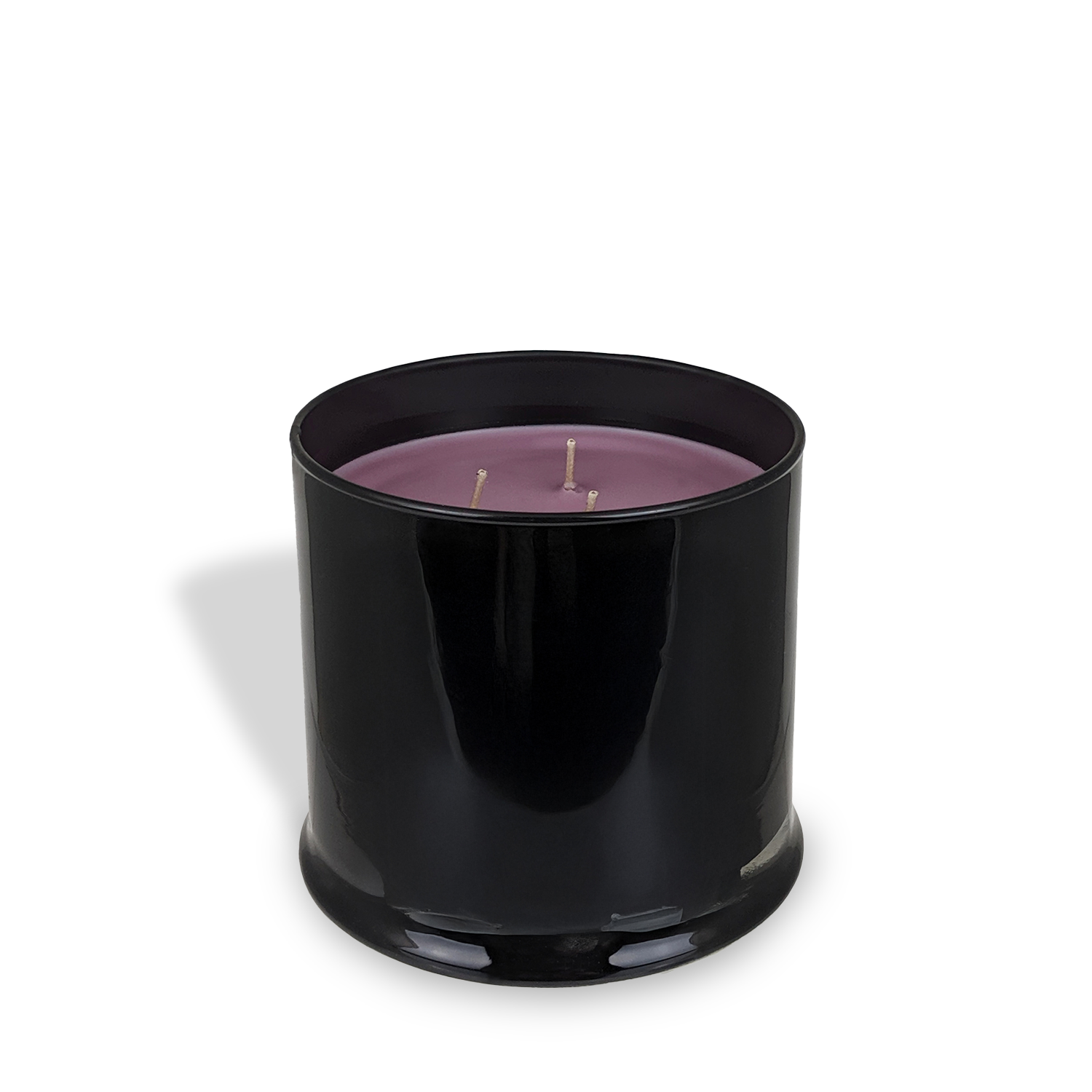 A black glass jar from Tuscany Candle® EVD's Homme + Heritage Collection holds a 15 oz Spiced Cashmere scented candle with three wicks, displayed on a white background with a faint shadow.