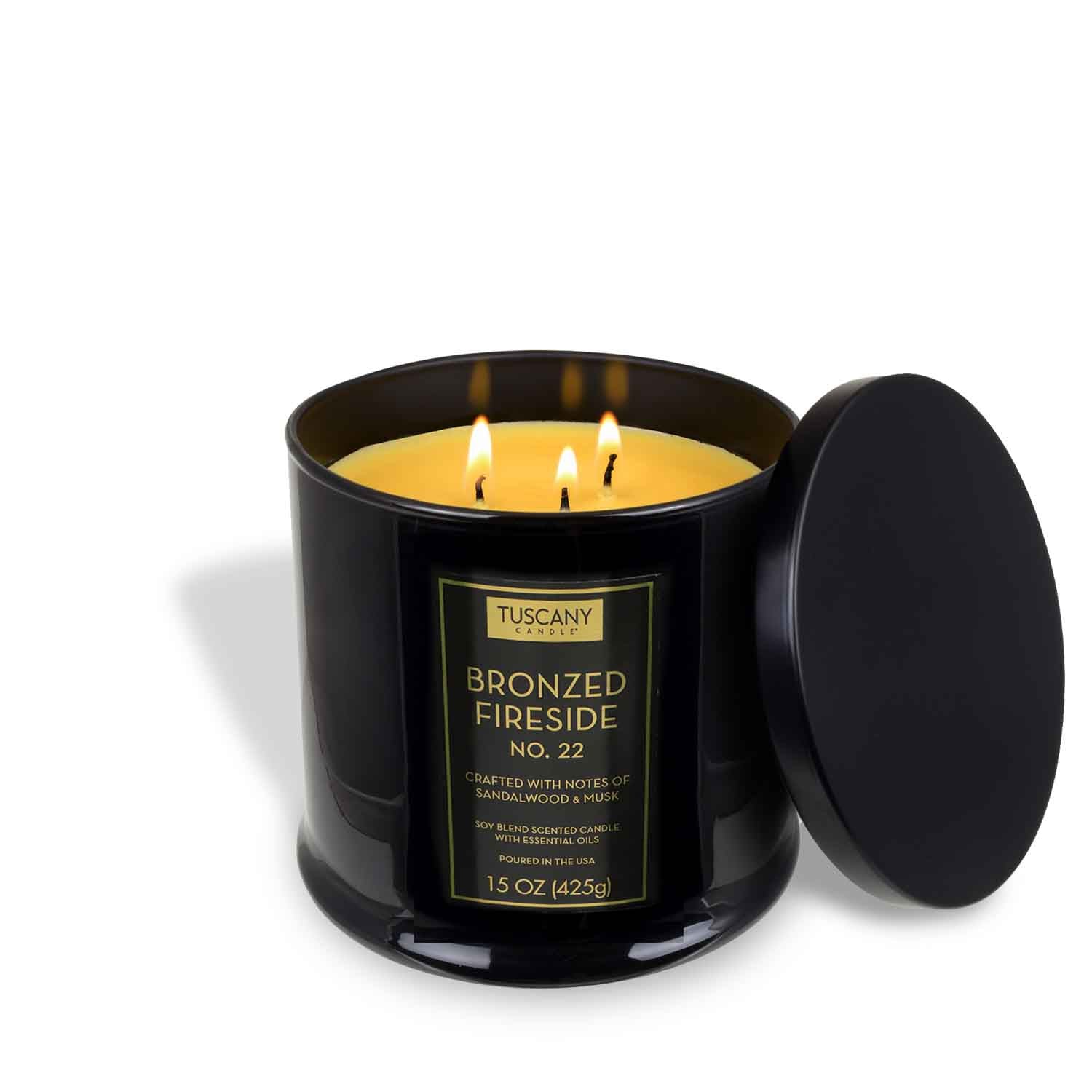 The Tuscany Candle® EVD Bronzed Fireside Scented Jar Candle (15 oz) from the Homme + Heritage Collection, with three wicks and sleek black glass, creates a bold and inviting ambiance.