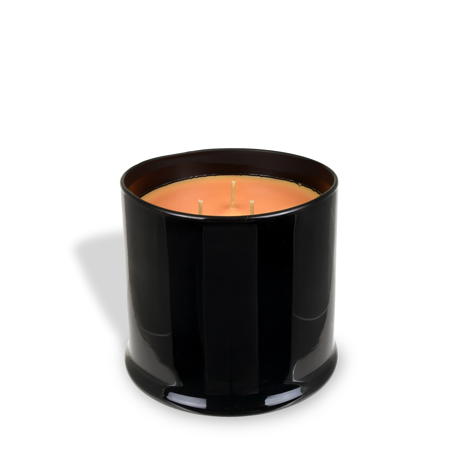 A black glass jar from Tuscany Candle® EVD’s Homme + Heritage Collection holds the 15 oz Amber Oud Scented Candle, featuring a rich, masculine aroma and orange three-wick glow against a white background.
