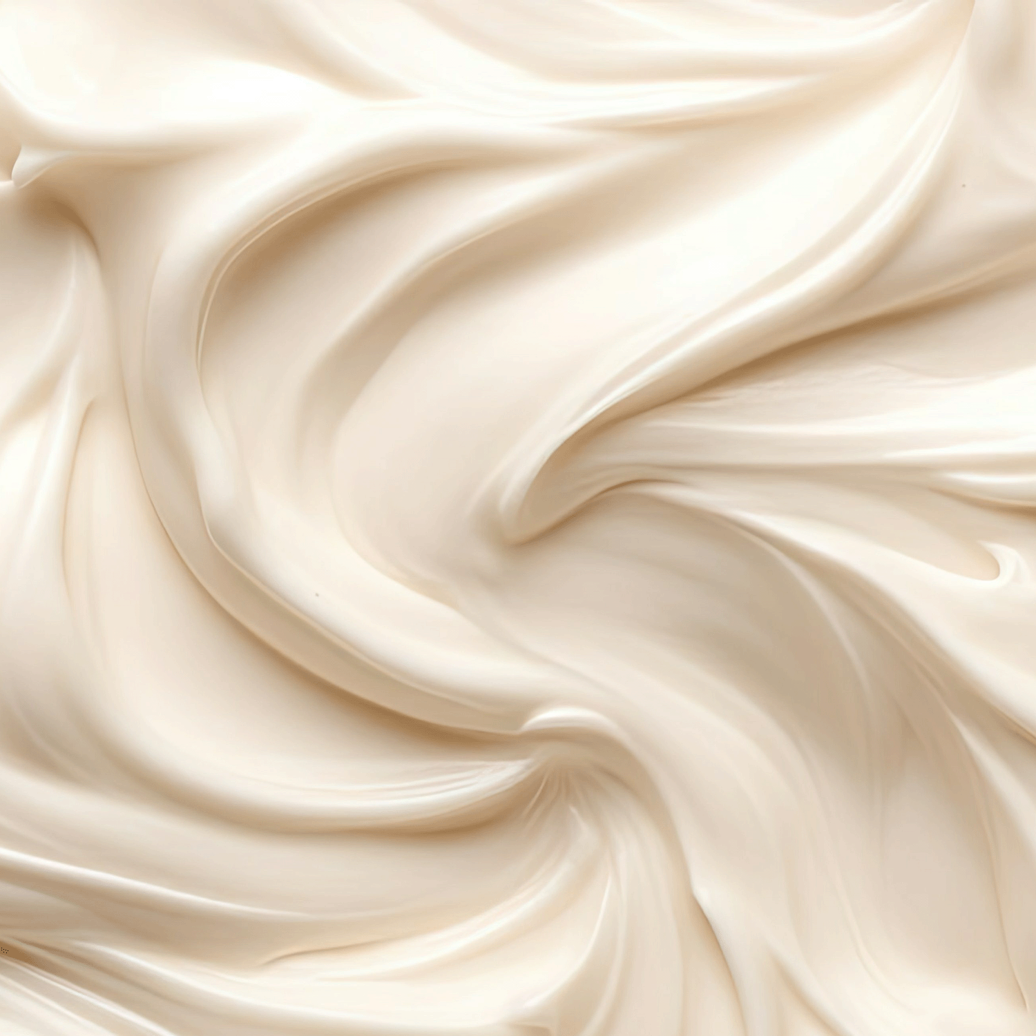 Close-up image of the smooth, creamy substance with swirled, wave-like patterns in shades of beige and off-white, reminiscent of the rich texture found in our Iced Pumpkin Cake Long-Lasting Scented Jar Candle (12 oz) from the Tuscany Candle® SEASONAL Copper Harvest Collection.