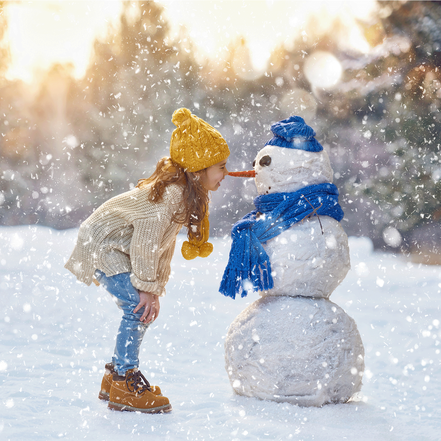 In an evergreen forest, a child wearing a yellow hat leans toward a snowman adorned with a blue scarf and hat, as gentle snowflakes fall, creating a picturesque winter scene reminiscent of the Tree Farm Scented Jar Candle by Tuscany Candle® SEASONAL.