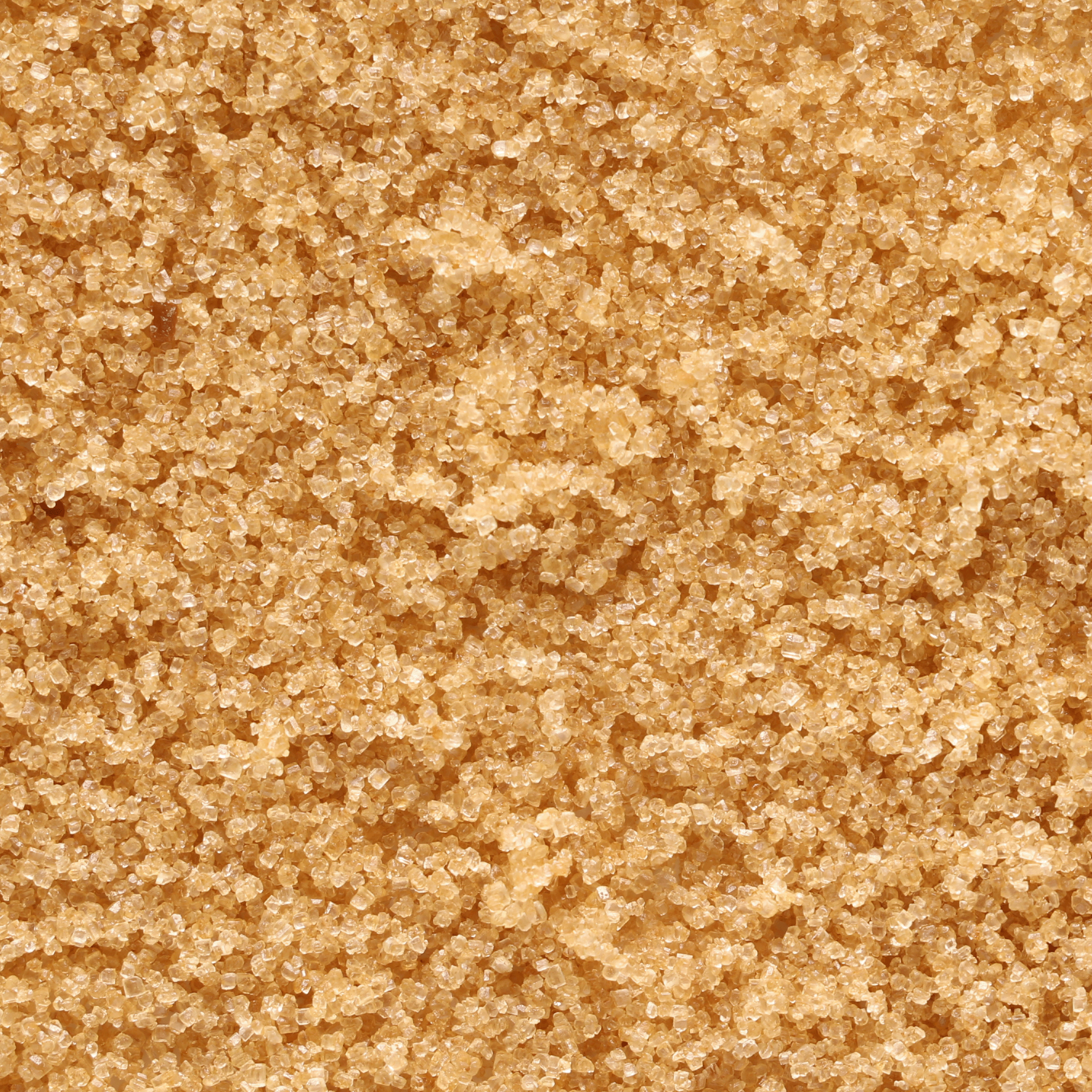 Close-up of light brown sugar crystals, highlighting their granular texture—ideal for the Tuscany Candle® SEASONAL Autumn Oatmeal Cookie: Harvest Spices Scented Fall Candle (12 oz) from the Bakery Tins Collection.