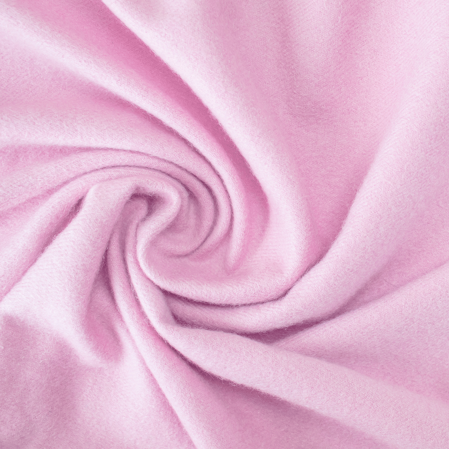 Close-up of soft, light pink fleece fabric in a spiral, highlighting its smooth, cozy texture—perfect for relaxing with the Tuscany Candle® SEASONAL Festive Holiday Cardigan Scented Holiday Candle (14 oz).