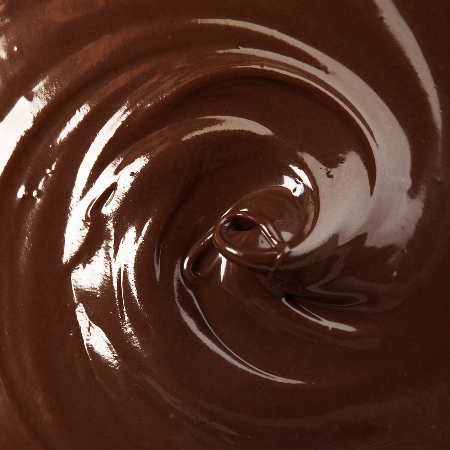 Close-up view of smooth, glossy melted chocolate inspires the Chocolate Cherries: Cherry Cordial Scented Valentine's Candle (18 oz) by Tuscany Candle® SEASONAL.