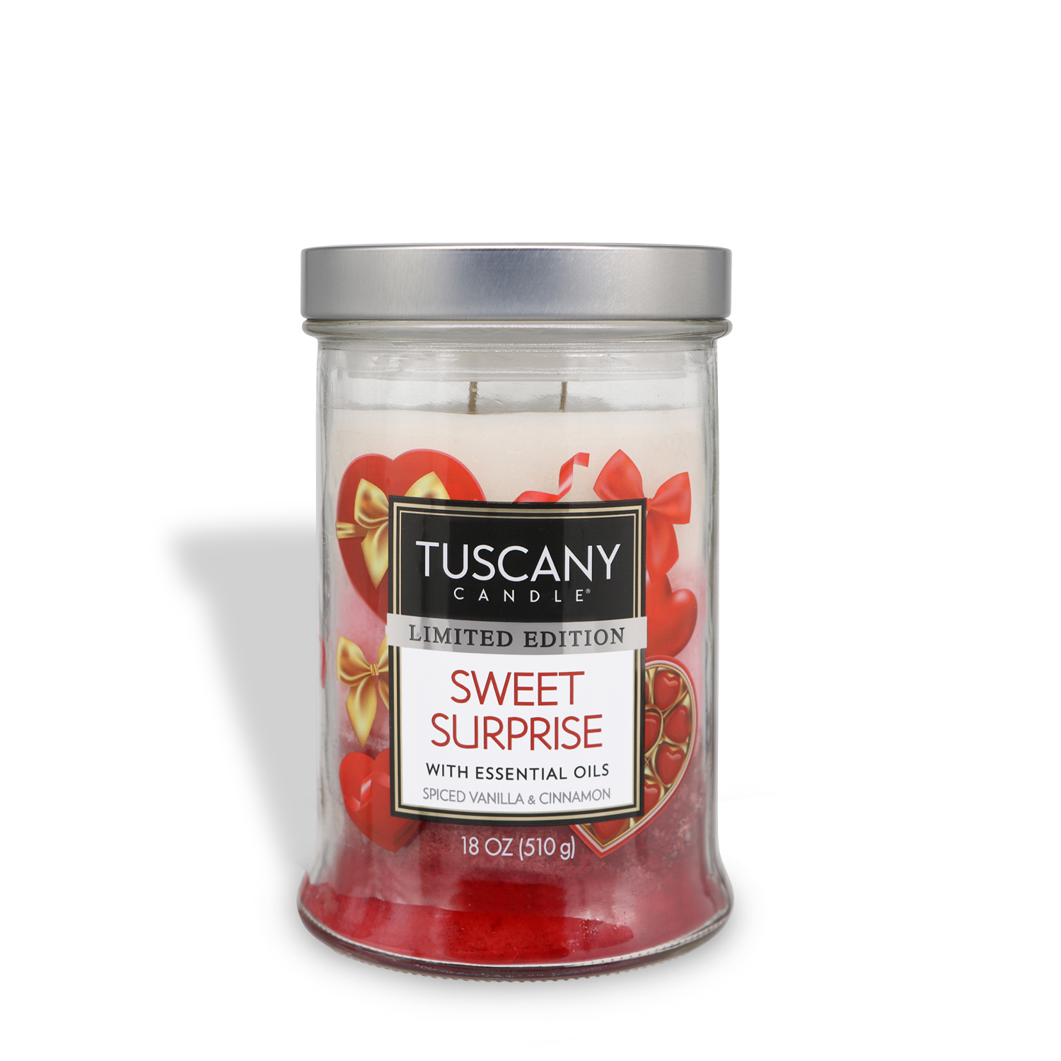 An 18 oz glass jar candle by Tuscany Candle® SEASONAL, labeled "Sweet Surprise: Vanilla & Cinnamon Scented Valentine's Candle," featuring red wax and heart-shaped decorations inside.