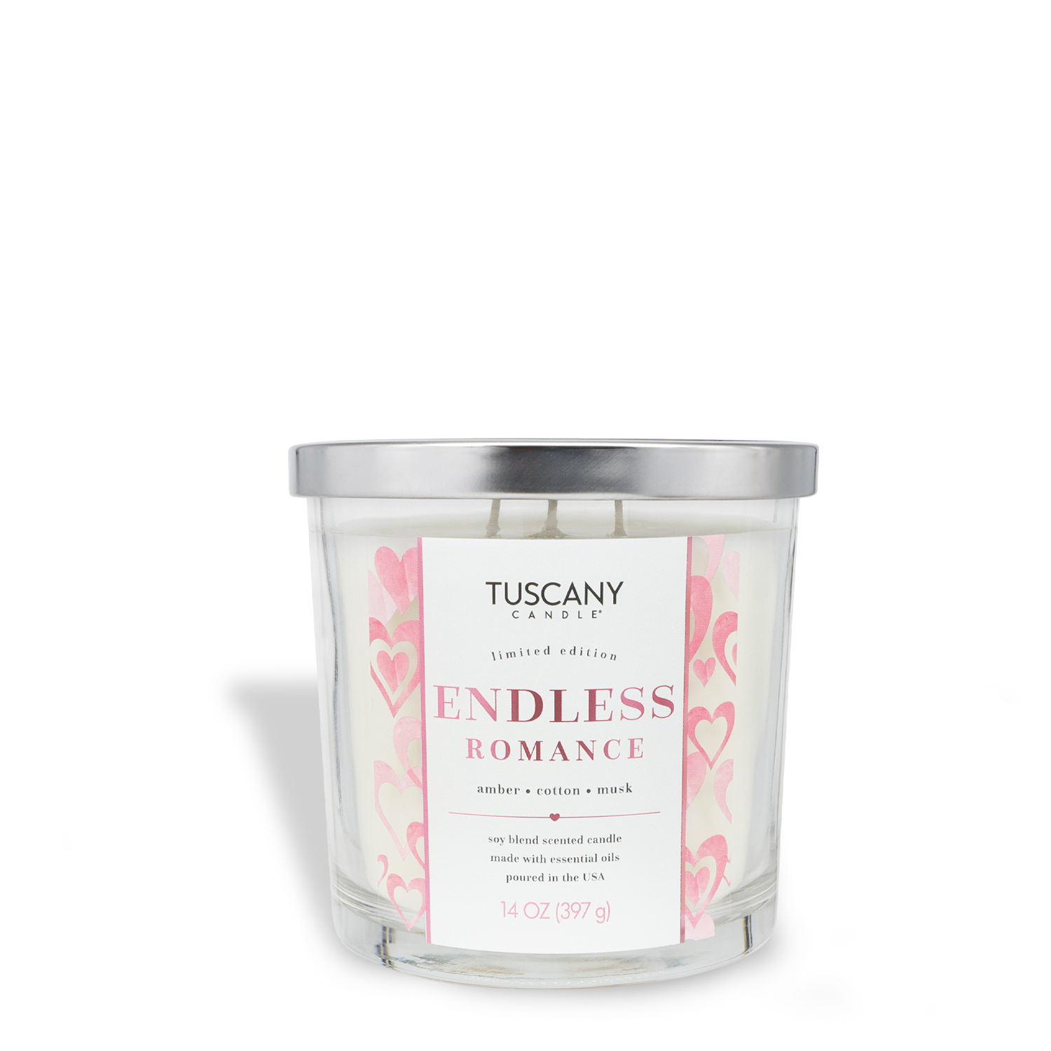 A 14 oz glass jar candle by Tuscany Candle® SEASONAL, labeled "Endless Romance: Amber & Musk Scented Valentine's Candle," features a pink hearts design and metal lid.