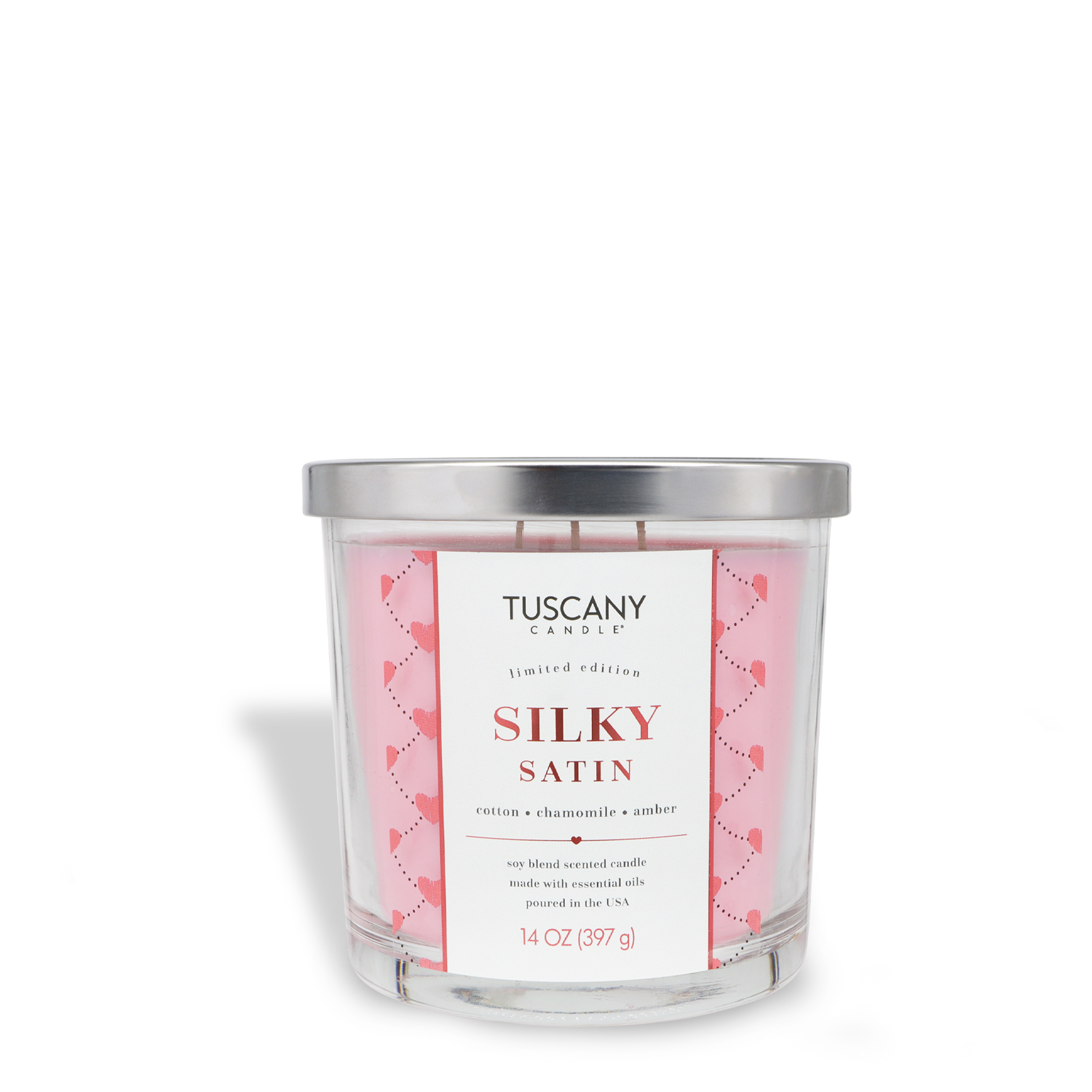 The Tuscany Candle® SEASONAL Silky Satin: Cotton & Chamomile Scented Valentine's Candle (14 oz) comes in a clear glass jar with a silver lid, featuring notes of cotton, chamomile, and amber.