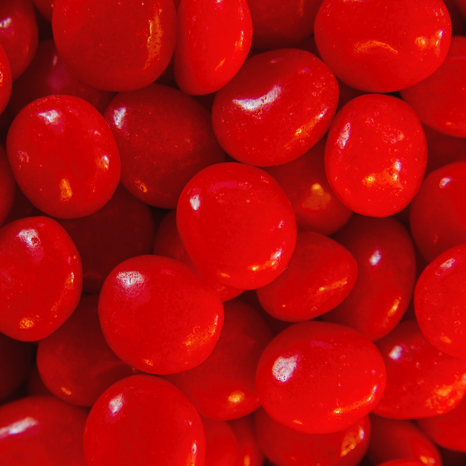 A close-up of the Tuscany Candle® SEASONAL "Be My Valentine" 14 oz candle, featuring a shiny red hot cinnamon-inspired design perfect for Valentine's Day.