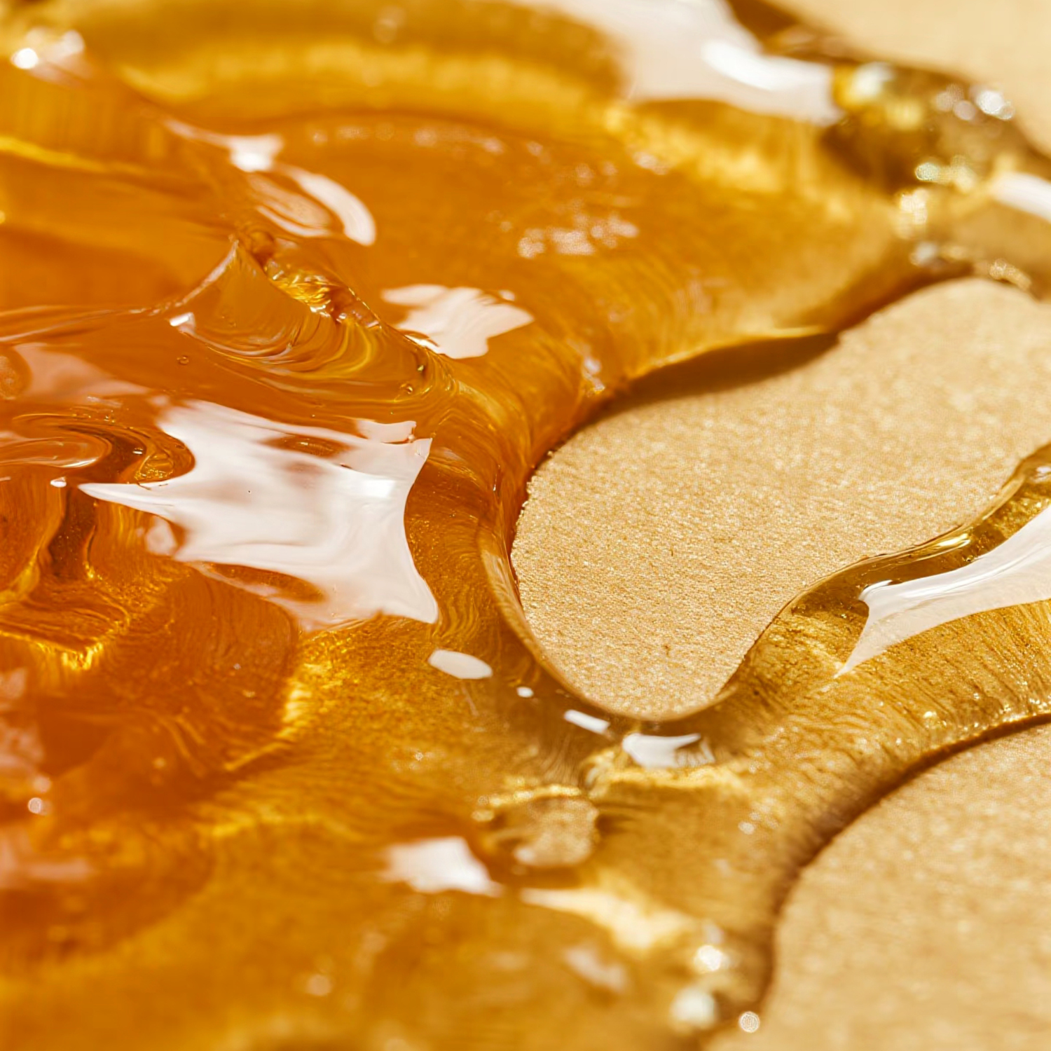 Close-up of golden honey spread on a smooth surface, evoking the warm glow and sweetness of Tuscany Candle® EVD's Homemade Muffins Scented Jar Candle (10 oz) from the Farmhouse Collection.