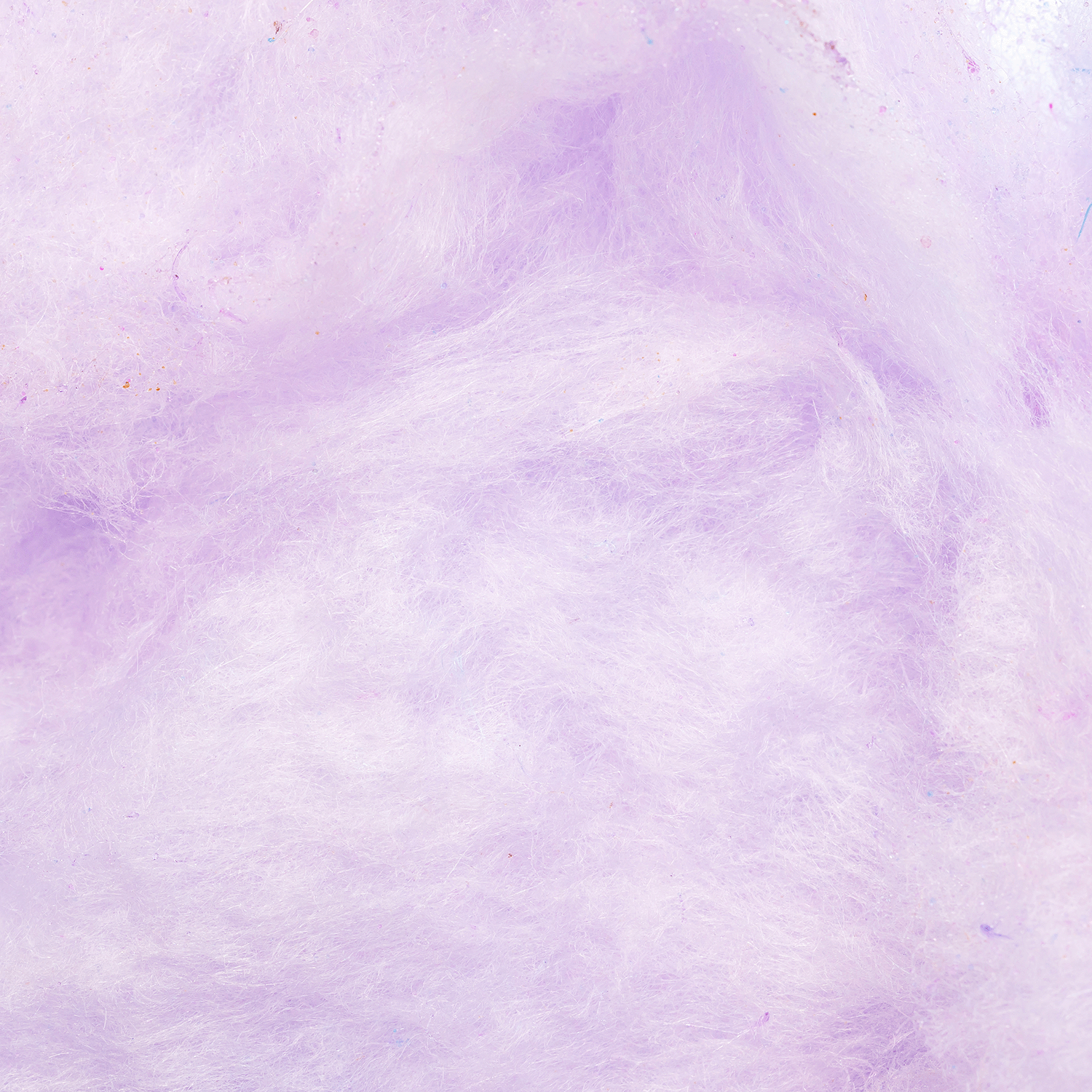 Close-up of fluffy, light purple Carnival Sweets: Apples & Cotton Candy Grapes Wax Melt (2.5 oz) by Tuscany Candle® SEASONAL, evoking the sweet, fruity aroma and fibrous texture of fresh cotton candy grapes.