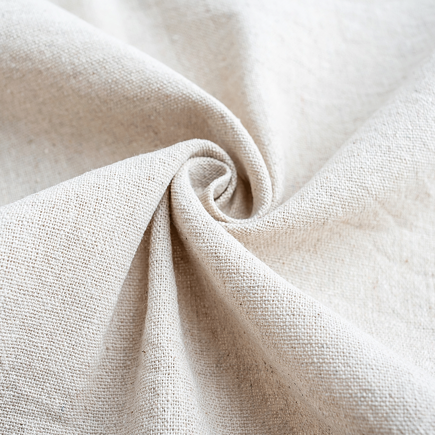 Close-up of Tuscany Candle® SEASONAL Sun-Dried Linens: Sunshine & Breeze Scented Spring Wax Melt (2.5 oz)—beige linen fabric twisted at the center evokes the refreshing scent and texture of sun-dried linens on a spring day.