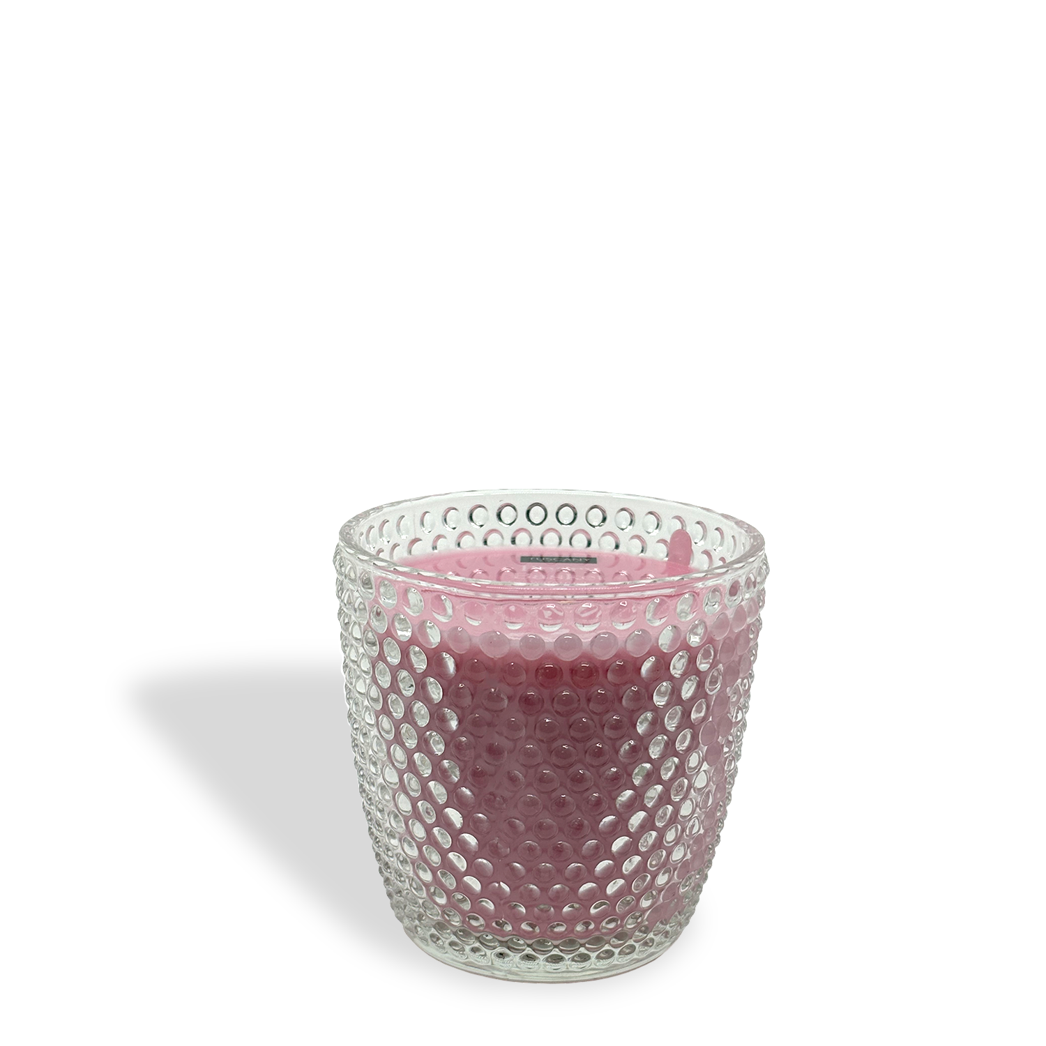 The Tuscany Candle® Berry Basket: Strawberry & Watermelon Scented Easter Candle (8.5 oz) features a pink wax in a clear, textured glass holder on a white background, casting a gentle shadow to the left.